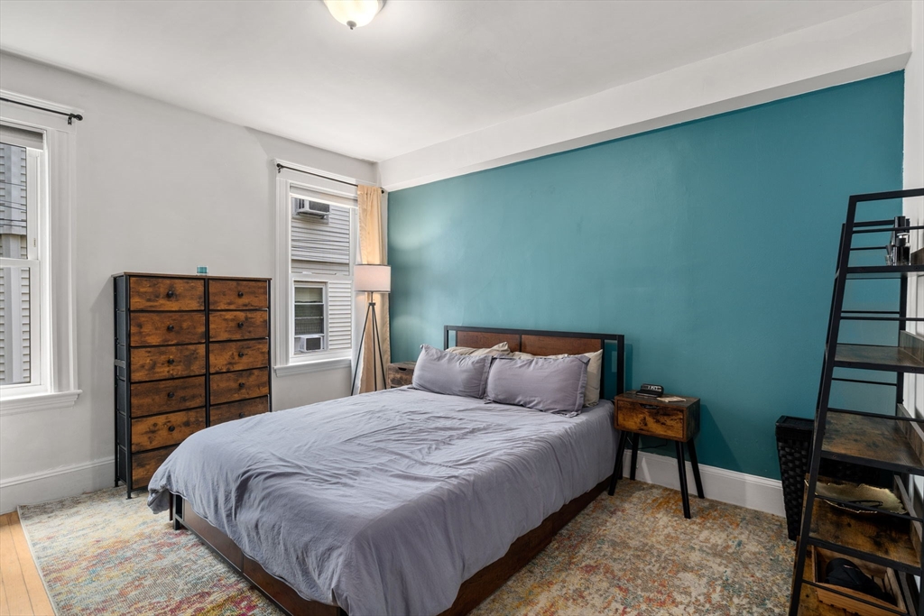 18 Park Road, Unit 1 Belmont, MA 02478 - Photo 25 of 36 a bedroom with a bed a dresser and book shelf
