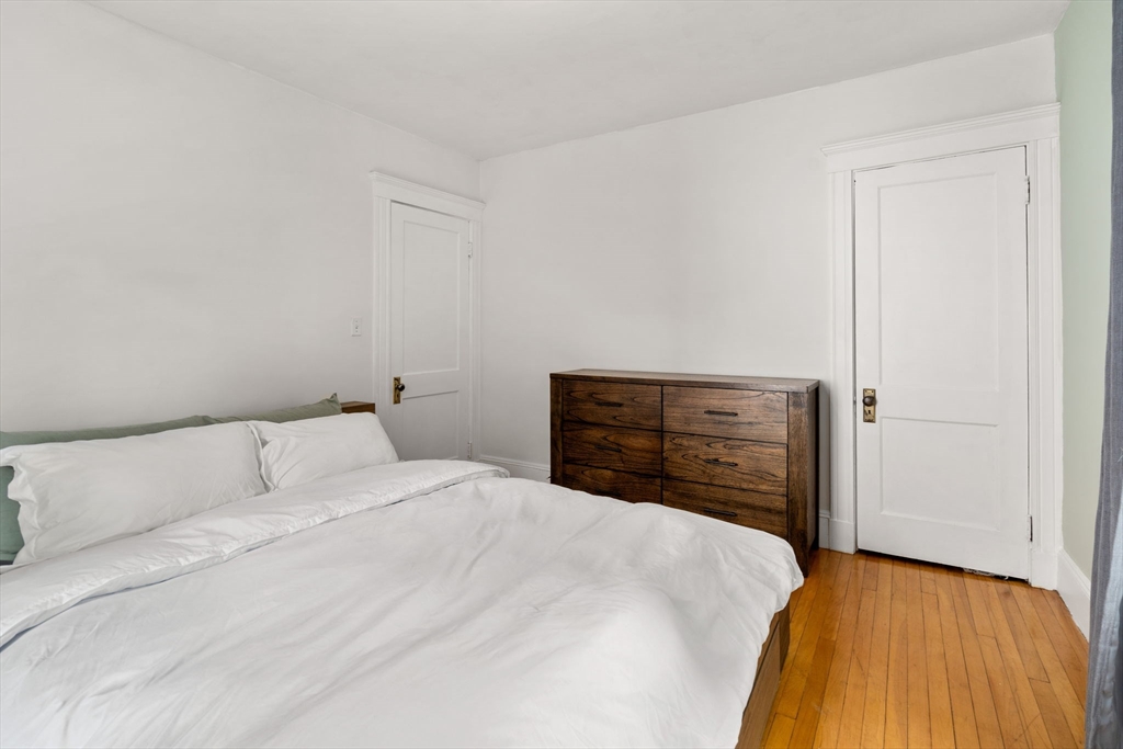 18 Park Road, Unit 1 Belmont, MA 02478 - Photo 28 of 36 a bedroom with a bed and a dresser