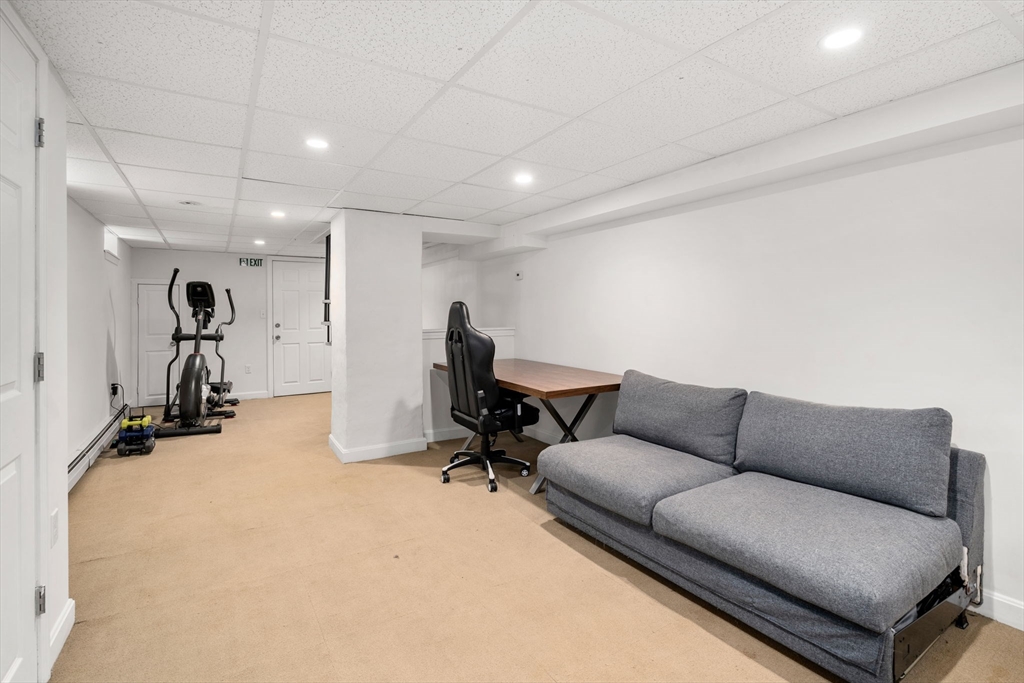 18 Park Road, Unit 1 Belmont, MA 02478 - Photo 30 of 36 a living room with furniture and a gym machine