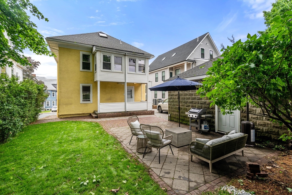 18 Park Road, Unit 1 Belmont, MA 02478 - Photo 32 of 36 a front view of a house with garden and sitting area