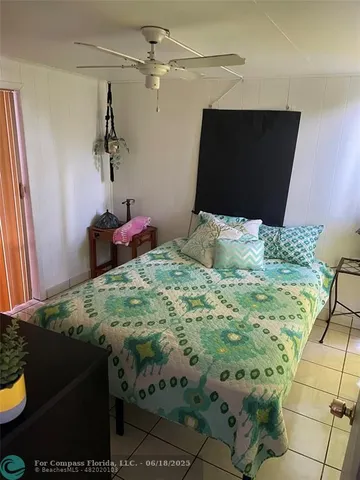 a bedroom with a bed and ceiling fan