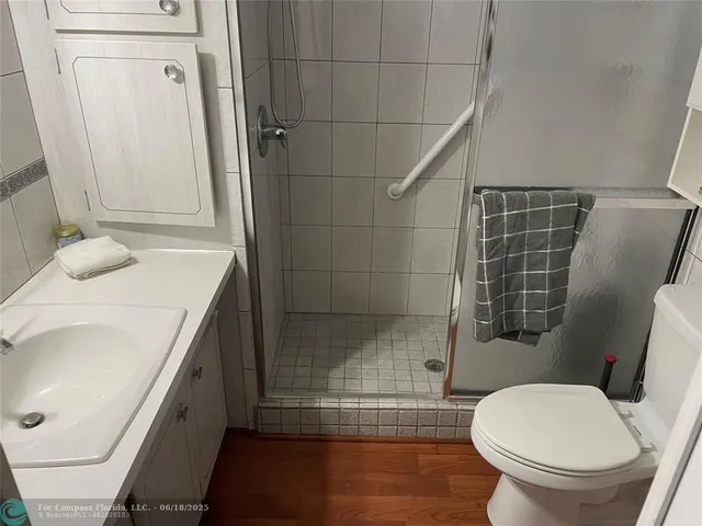 a bathroom with a sink a toilet and shower