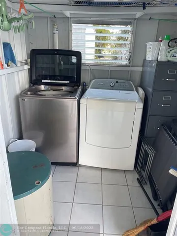 a kitchen with a stove a sink and a microwave