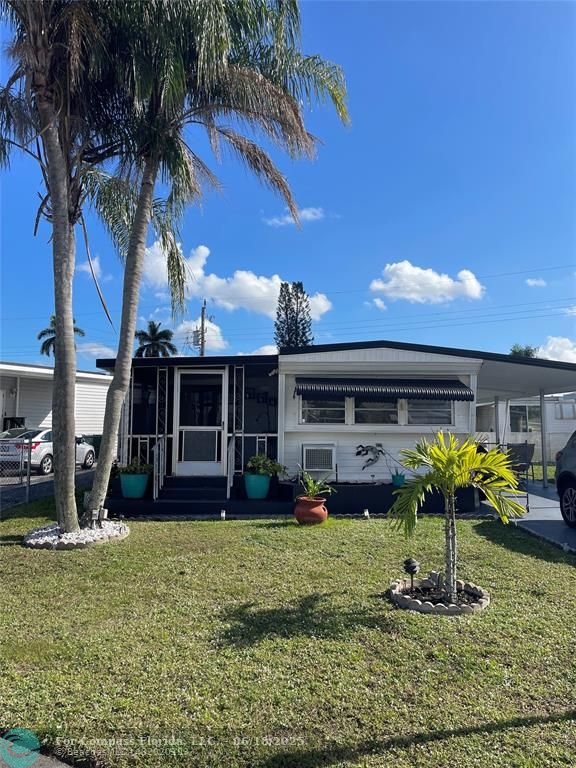 8610 Southwest 18th Court Davie, FL 33324 - Photo 2 of 17 a front view of a house with garden