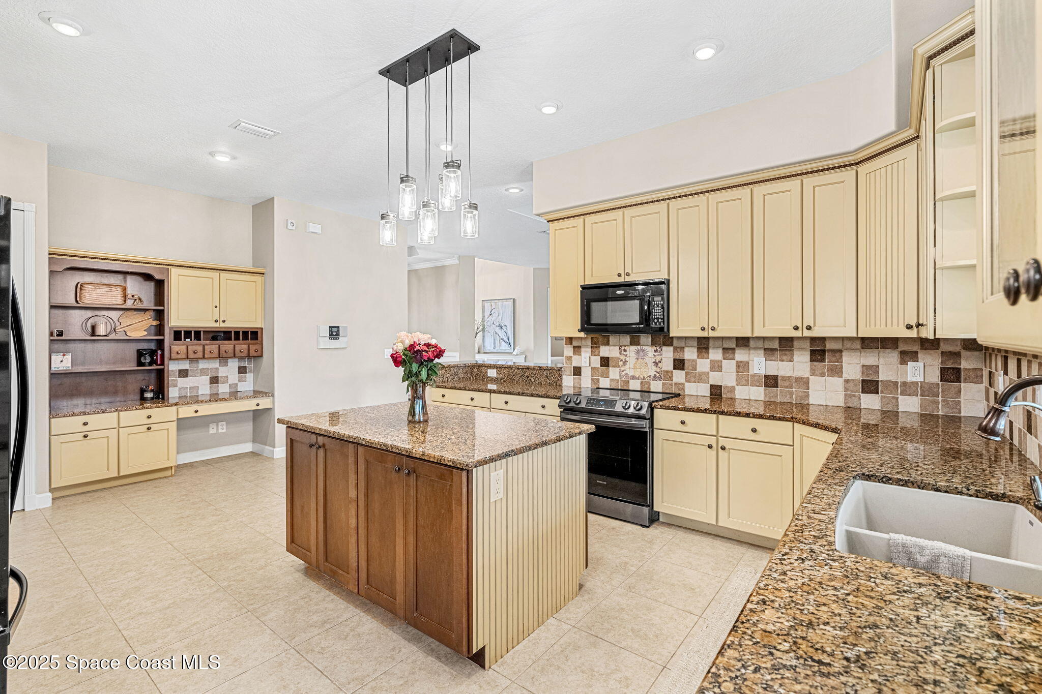 231 Loggerhead Drive Melbourne Beach, FL 32951 - Photo 11 of 47 a kitchen with stainless steel appliances granite countertop a sink and cabinets