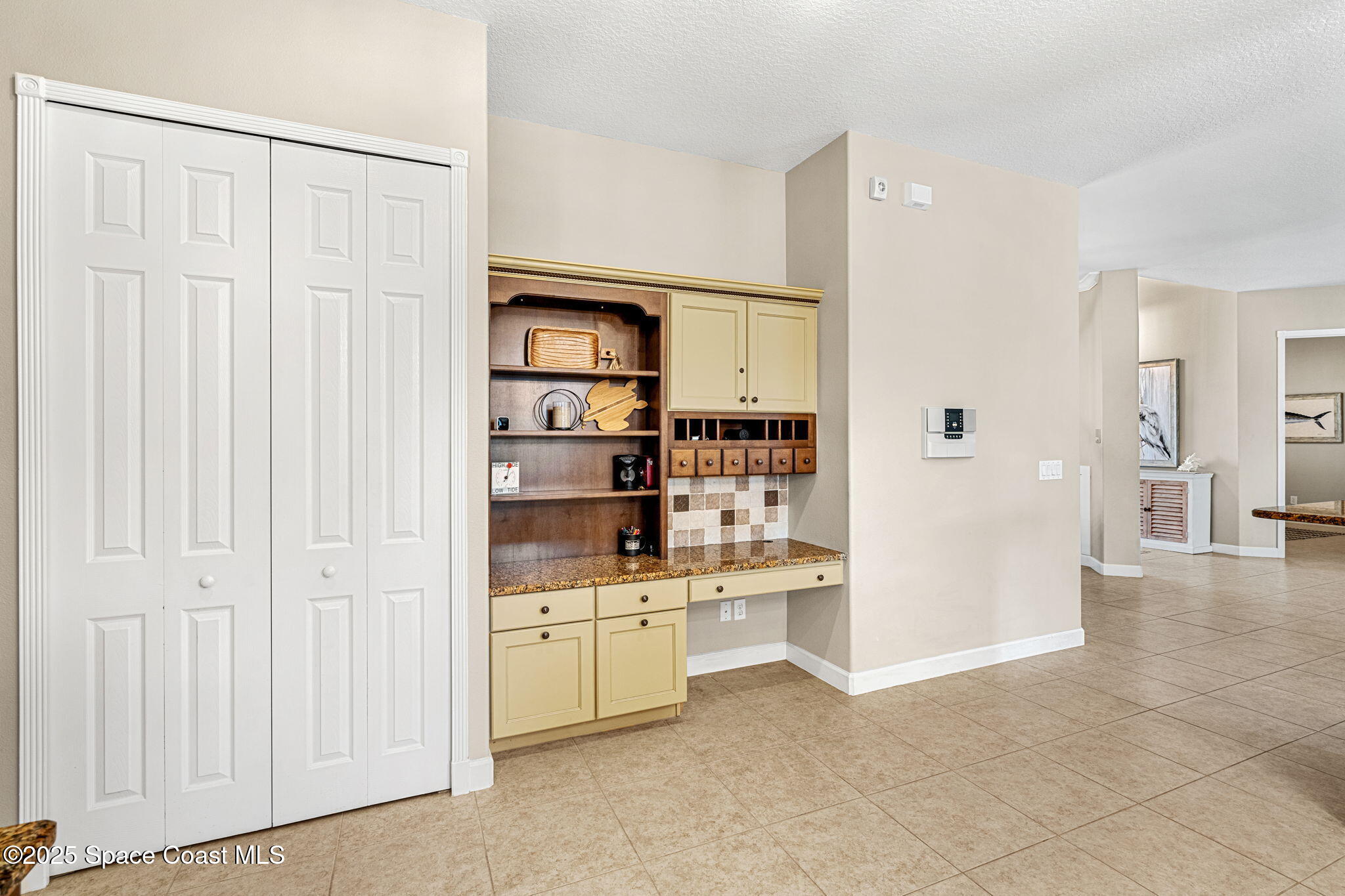 231 Loggerhead Drive Melbourne Beach, FL 32951 - Photo 12 of 47 a view of kitchen with white cabinets and wooden floor