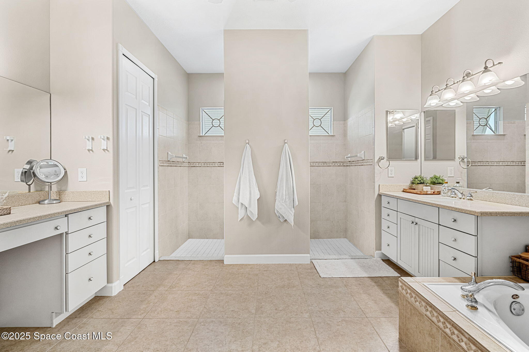 231 Loggerhead Drive Melbourne Beach, FL 32951 - Photo 14 of 47 a spacious bathroom with a granite countertop sink mirror and shower