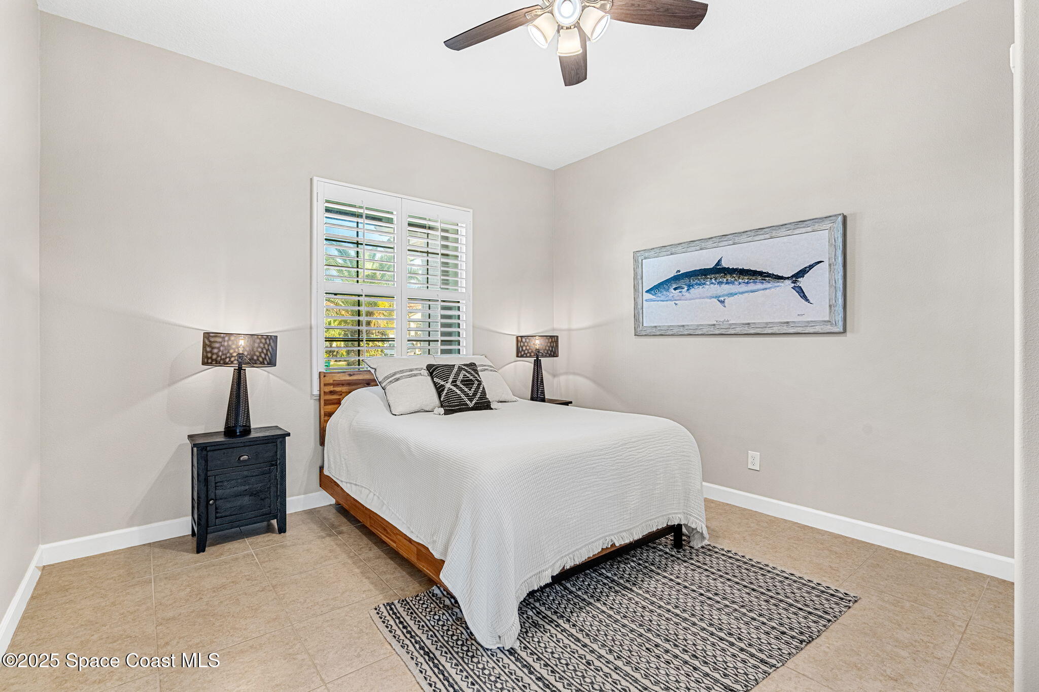 231 Loggerhead Drive Melbourne Beach, FL 32951 - Photo 16 of 47 a bedroom with a bed lamp and a window