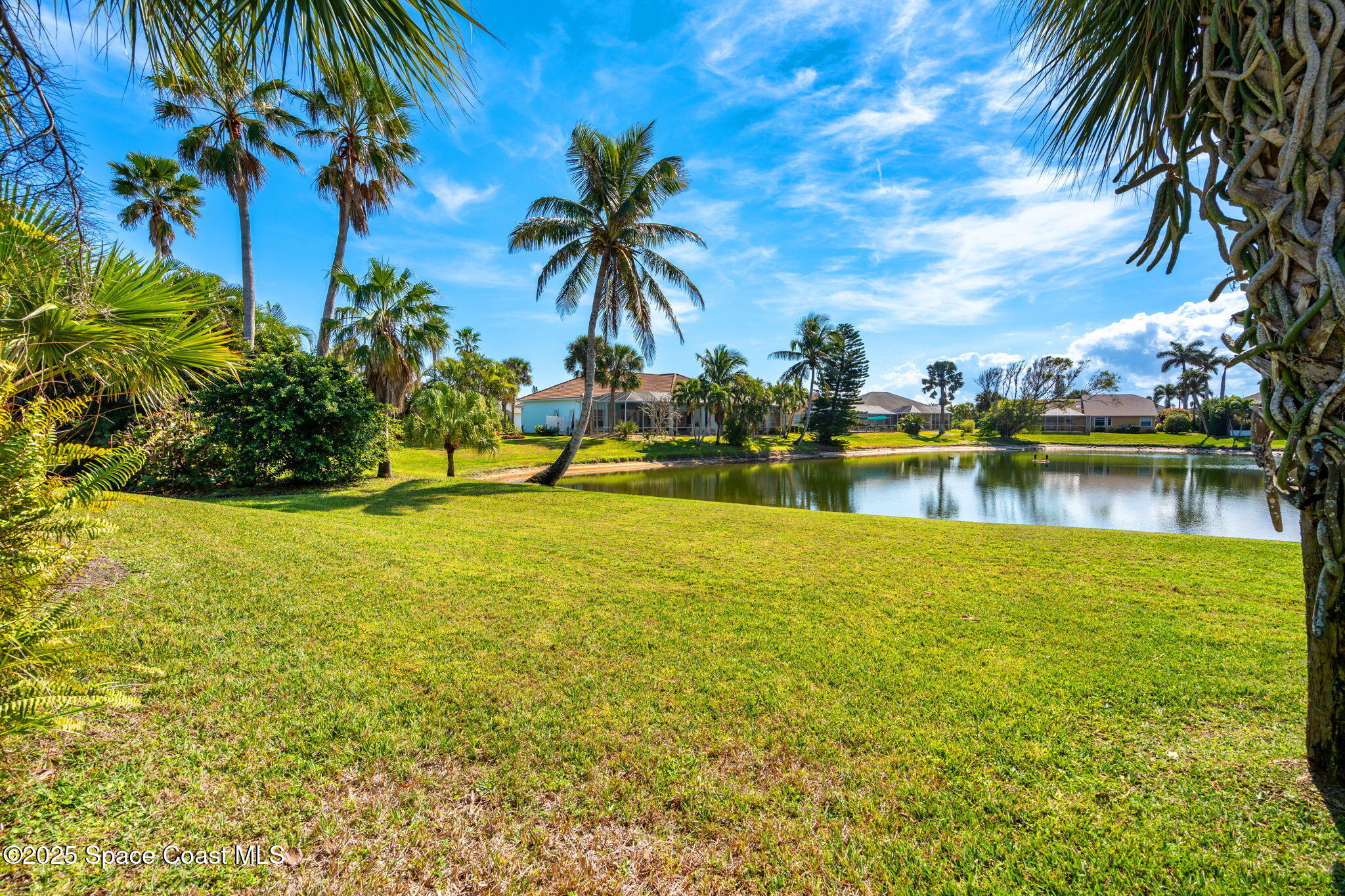 231 Loggerhead Drive Melbourne Beach, FL 32951 - Photo 28 of 47 a view of a lake with a garden