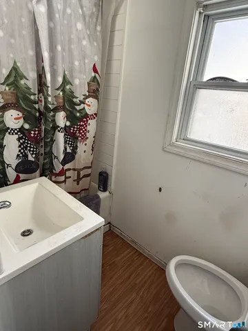 a living room with furniture chess board and a window