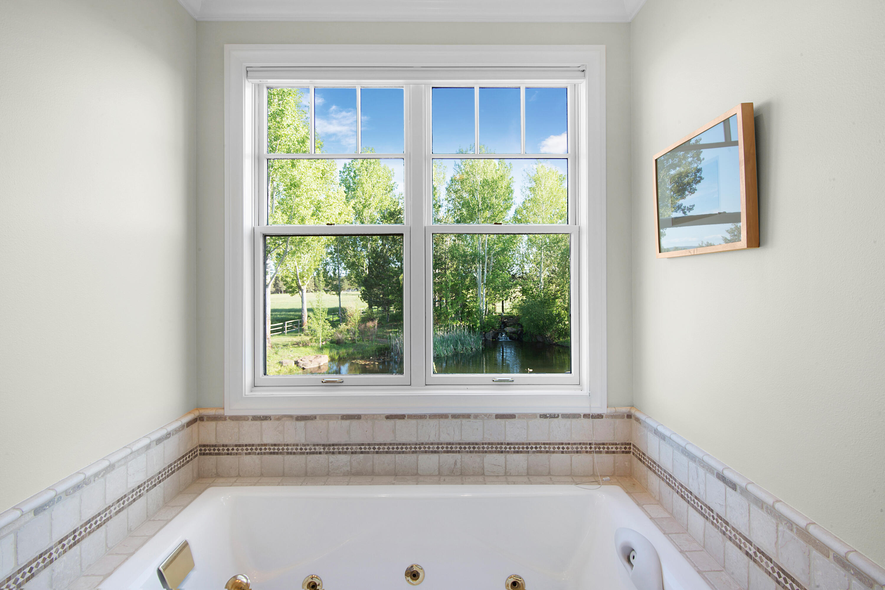 64950 Collins Road Bend, OR 97703 - Photo 43 of 87 a bathroom with a bathtub and window