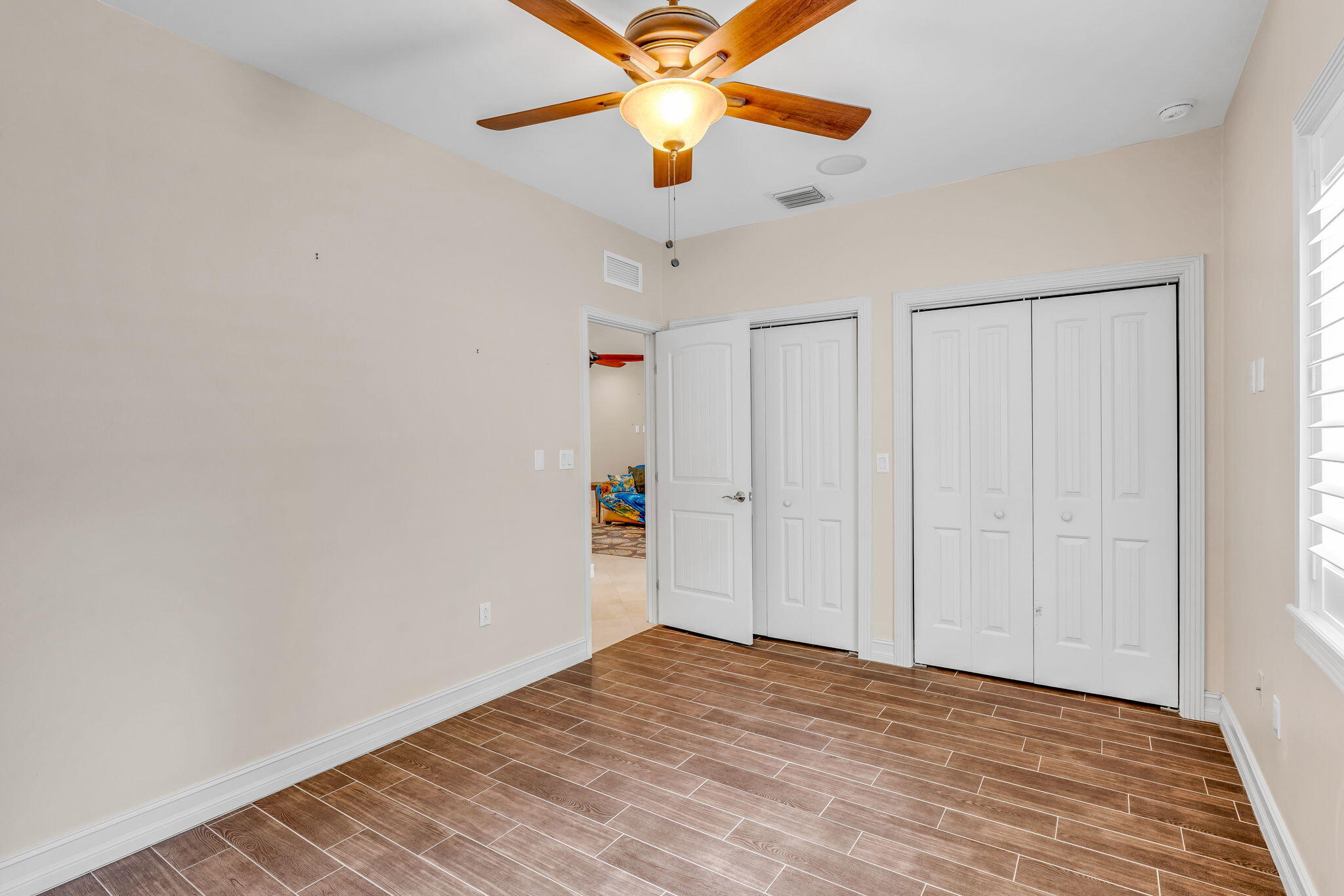 460 Lime Drive Key Largo, FL 33037 - Photo 25 of 49 a view of empty room with wooden floor and fan