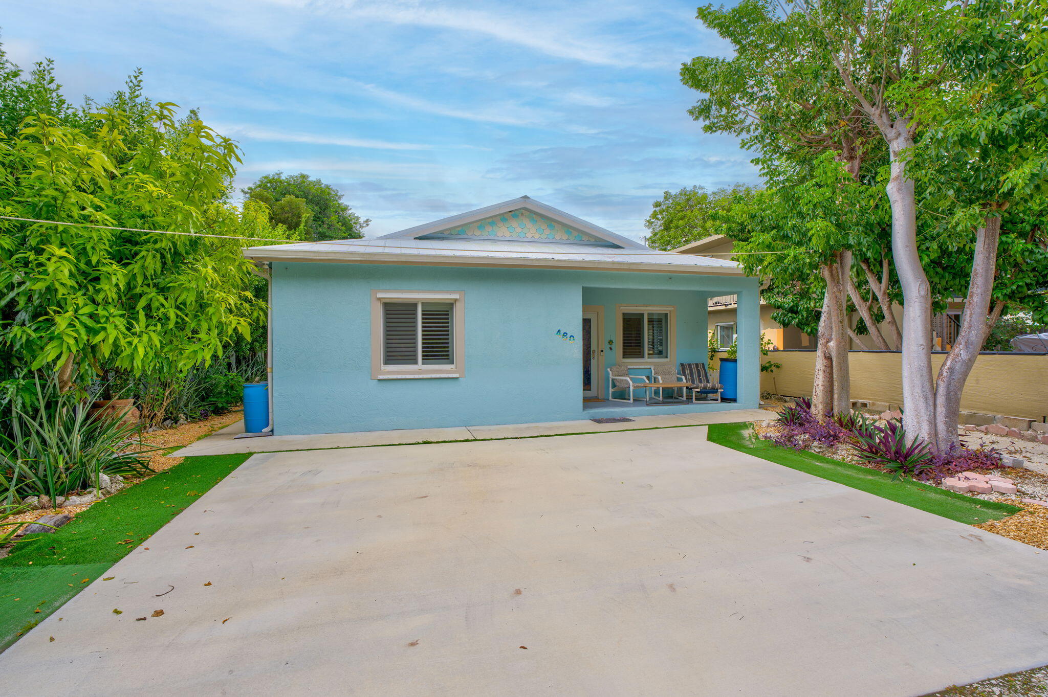 460 Lime Drive Key Largo, FL 33037 - Photo 31 of 49 a front view of a house with a yard and a garage