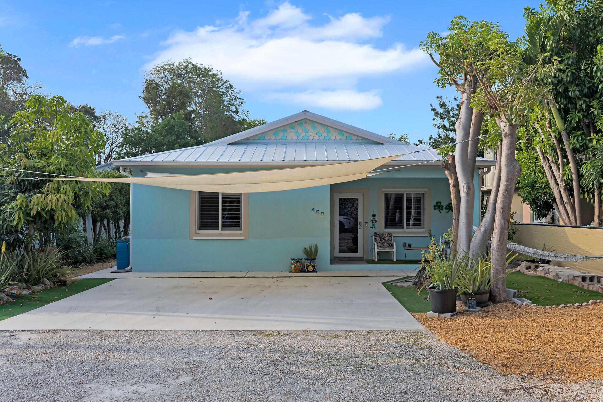 460 Lime Drive Key Largo, FL 33037 - Photo 43 of 49 a front view of a house with a yard and potted plants