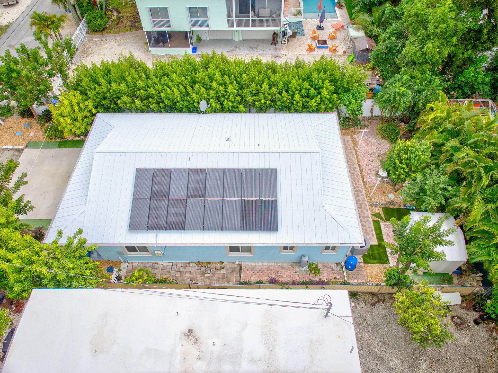 460 Lime Drive Key Largo, FL 33037 - Photo 45 of 49 a front view of a house with a yard and a garden