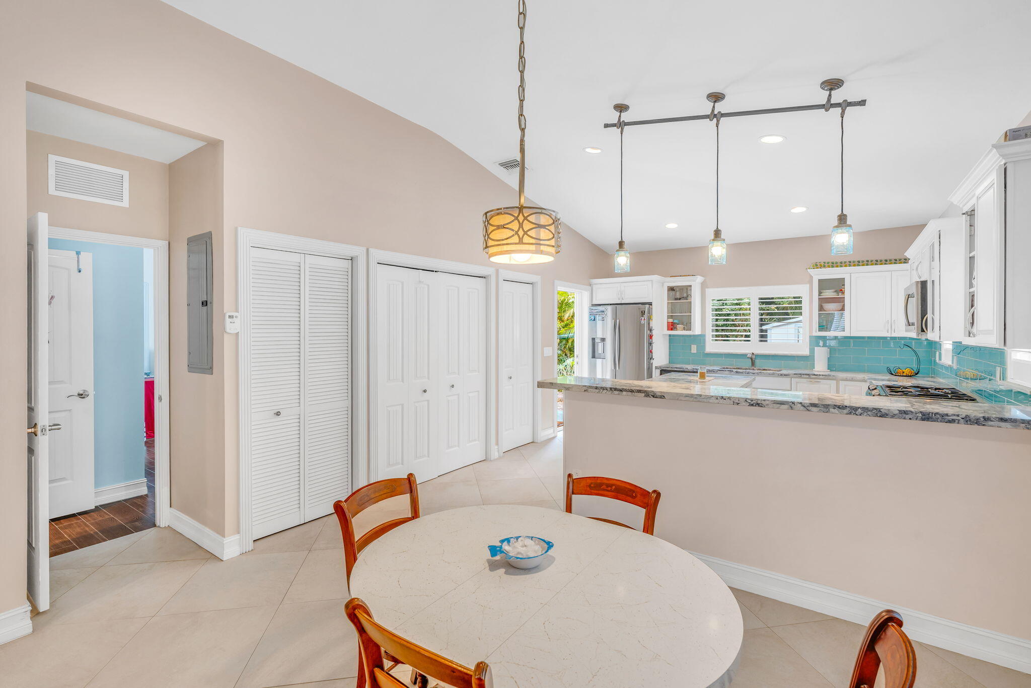 460 Lime Drive Key Largo, FL 33037 - Photo 6 of 49 a kitchen with stainless steel appliances granite countertop a sink a stove a refrigerator a dining table and chairs with wooden floor