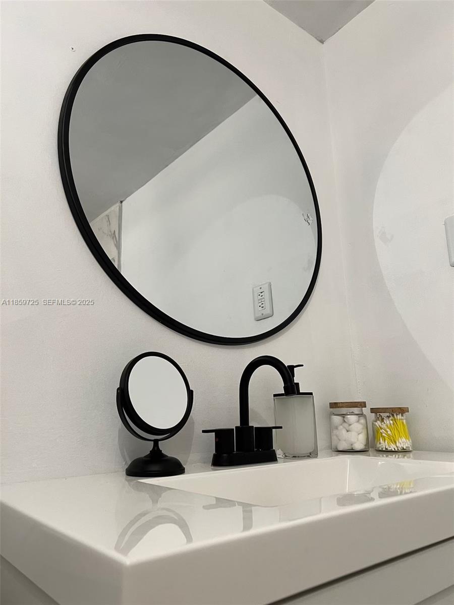 2701 Northwest 24th Court, Unit R Miami, FL 33142 - Photo 3 of 20 a bathroom with a sink and a mirror