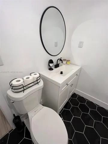 a bathroom with a toilet a sink and a mirror