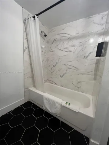 a bathroom with a bathtub and a shower