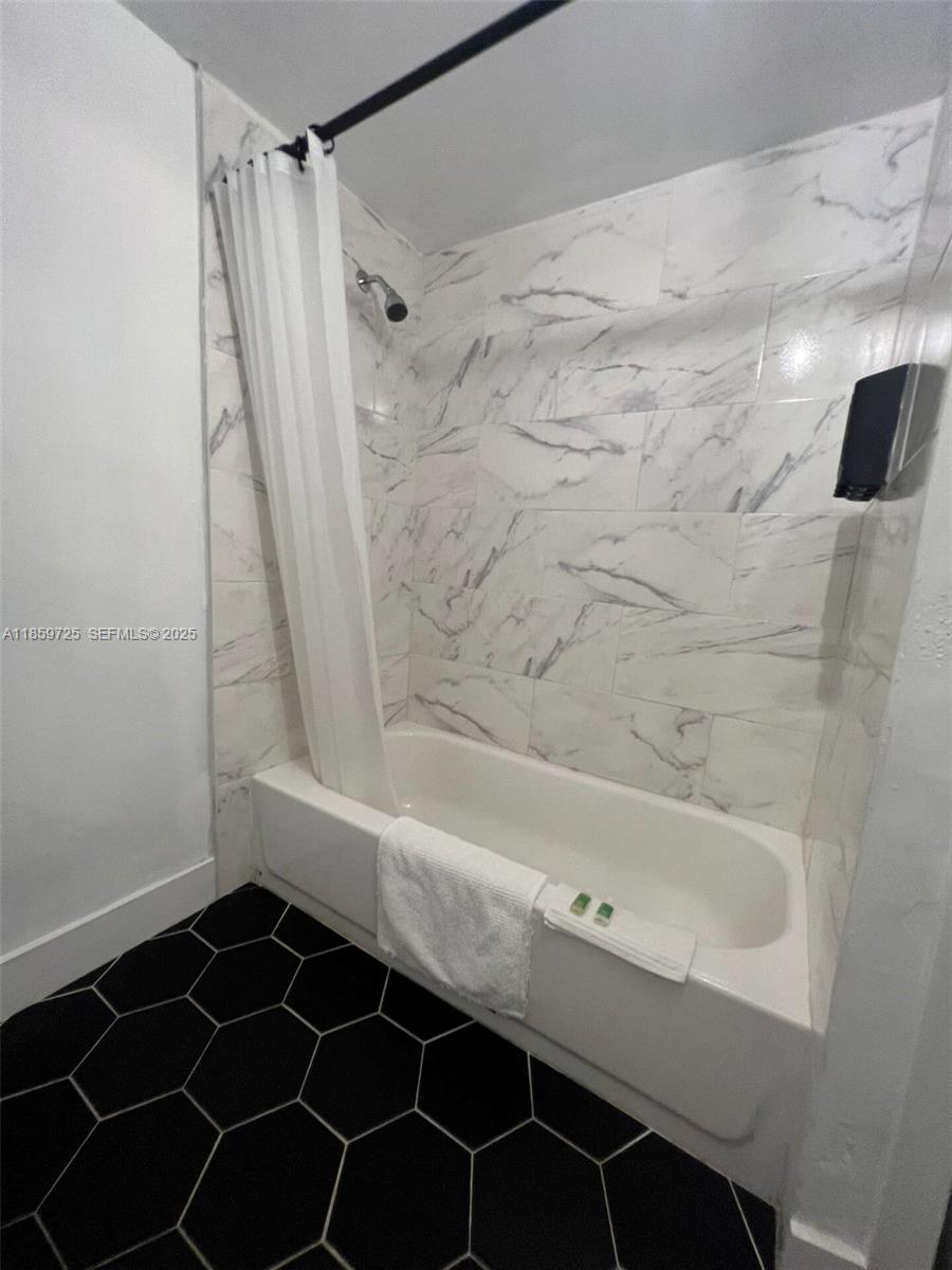 2701 Northwest 24th Court, Unit R Miami, FL 33142 - Photo 5 of 20 a bathroom with a bathtub and a shower
