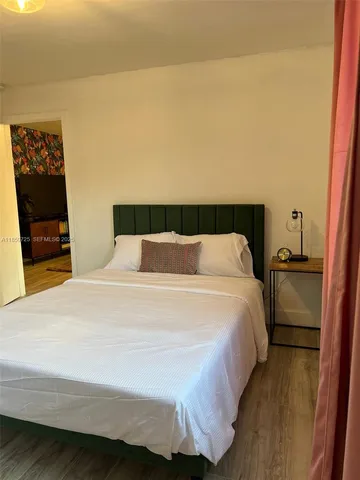 a bedroom with a bed and a night stand