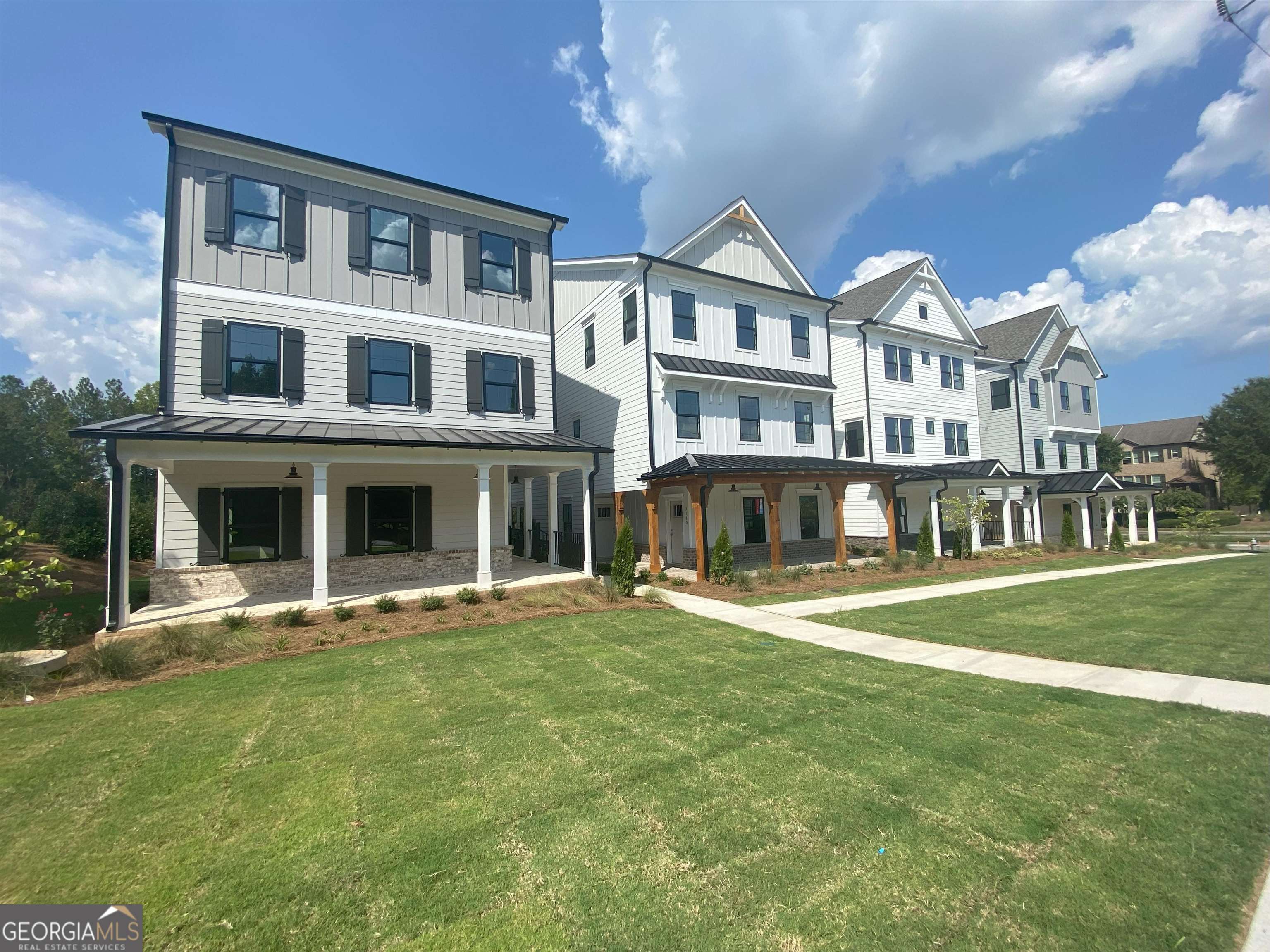 a front view of a residential apartment building with a yard