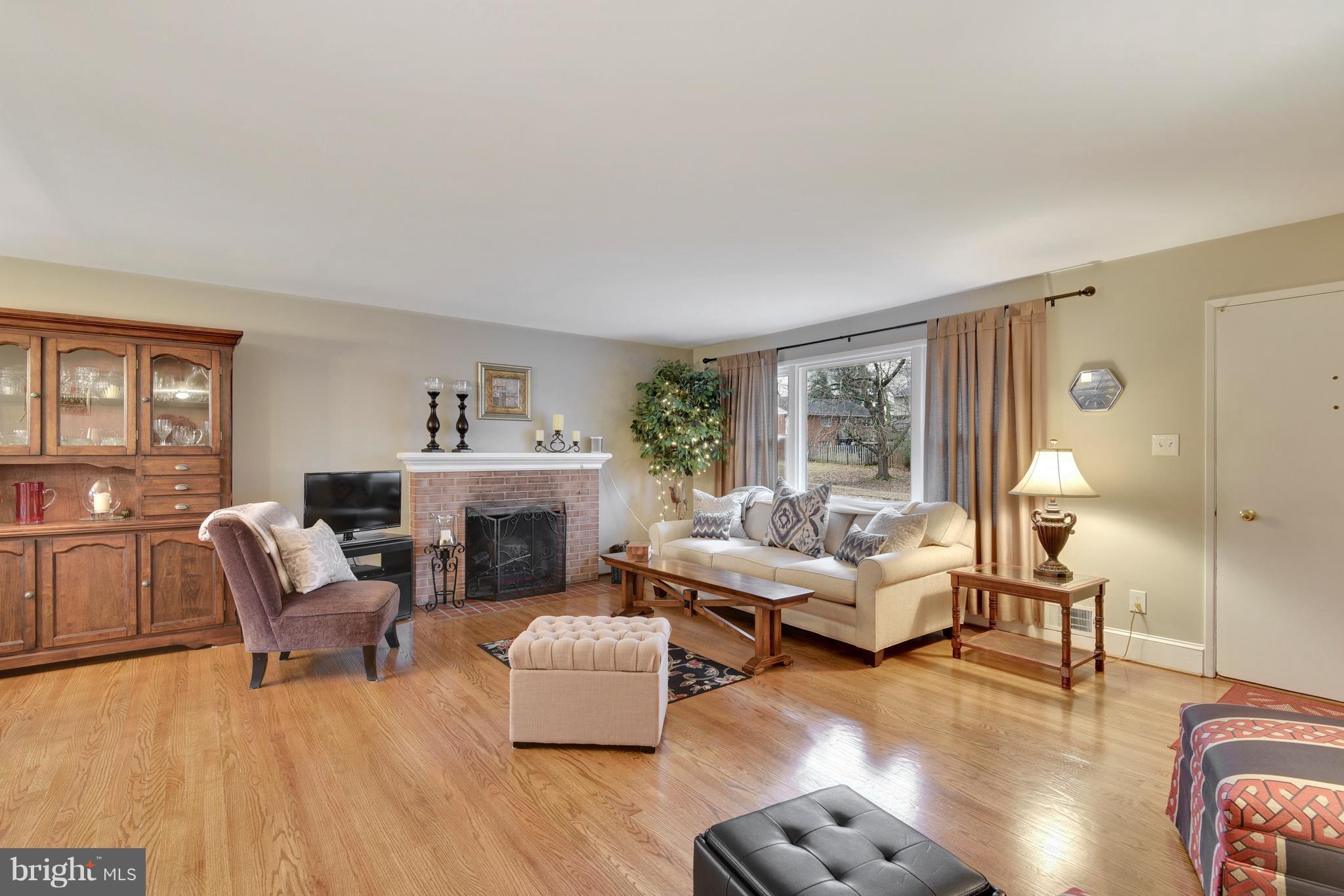 8108 Ellet Road Springfield, VA 22151 - Photo 2 of 21 a living room with furniture or chandelier and a wooden floor