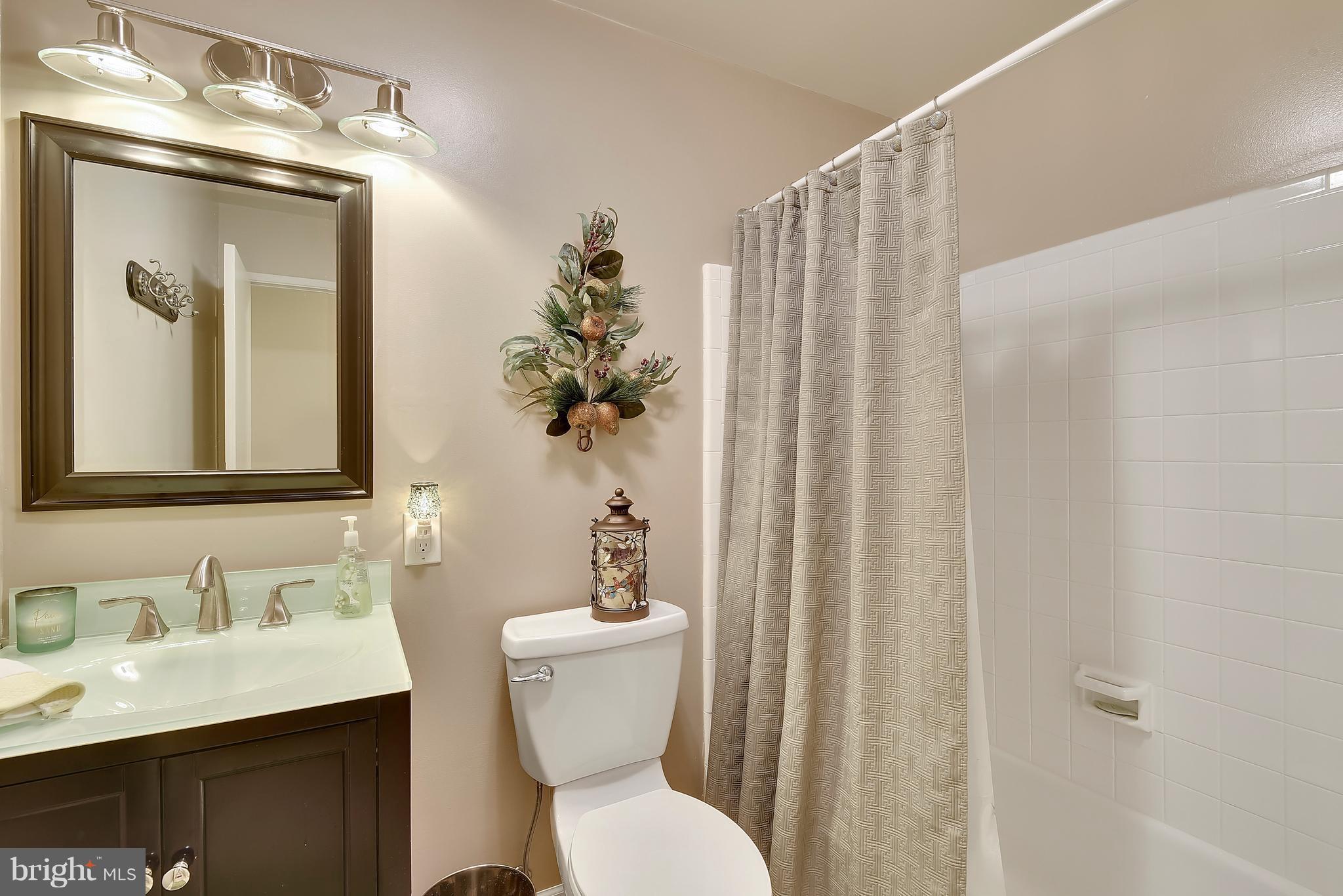 8108 Ellet Road Springfield, VA 22151 - Photo 12 of 21 a bathroom with a sink vanity mirror and toilet