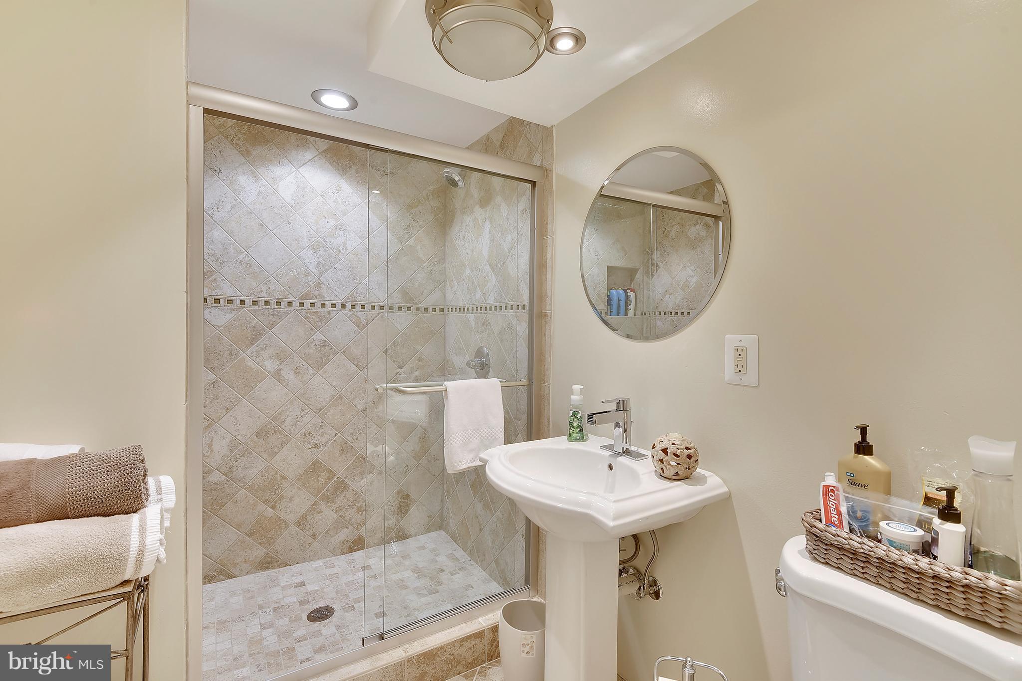 8108 Ellet Road Springfield, VA 22151 - Photo 15 of 21 a bathroom with a sink mirror and shower