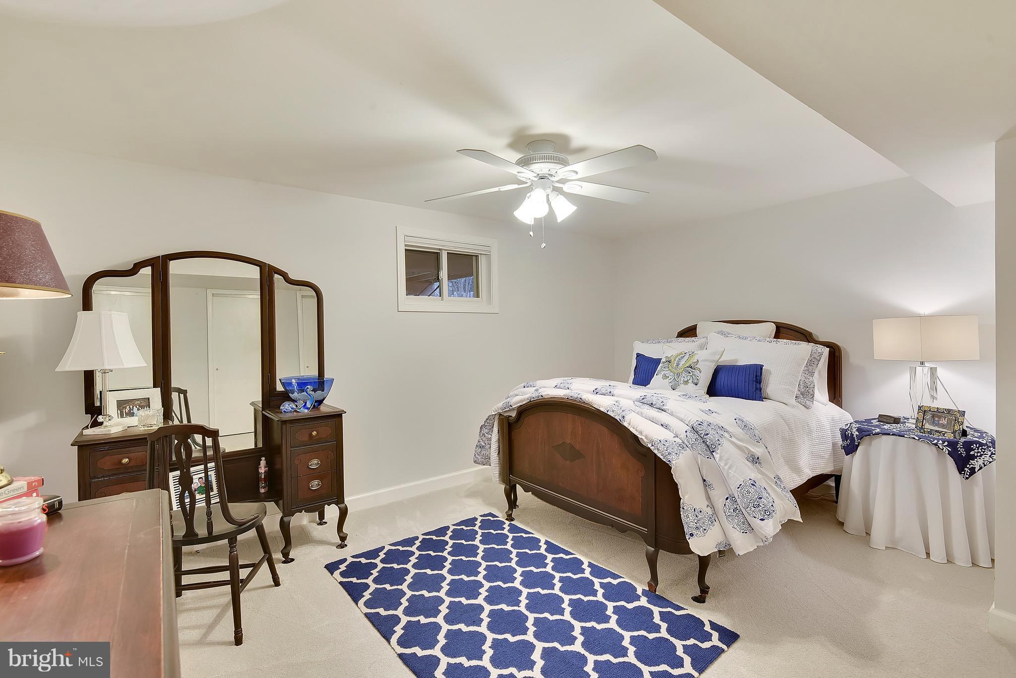 8108 Ellet Road Springfield, VA 22151 - Photo 17 of 21 a bedroom with bed and a chandelier