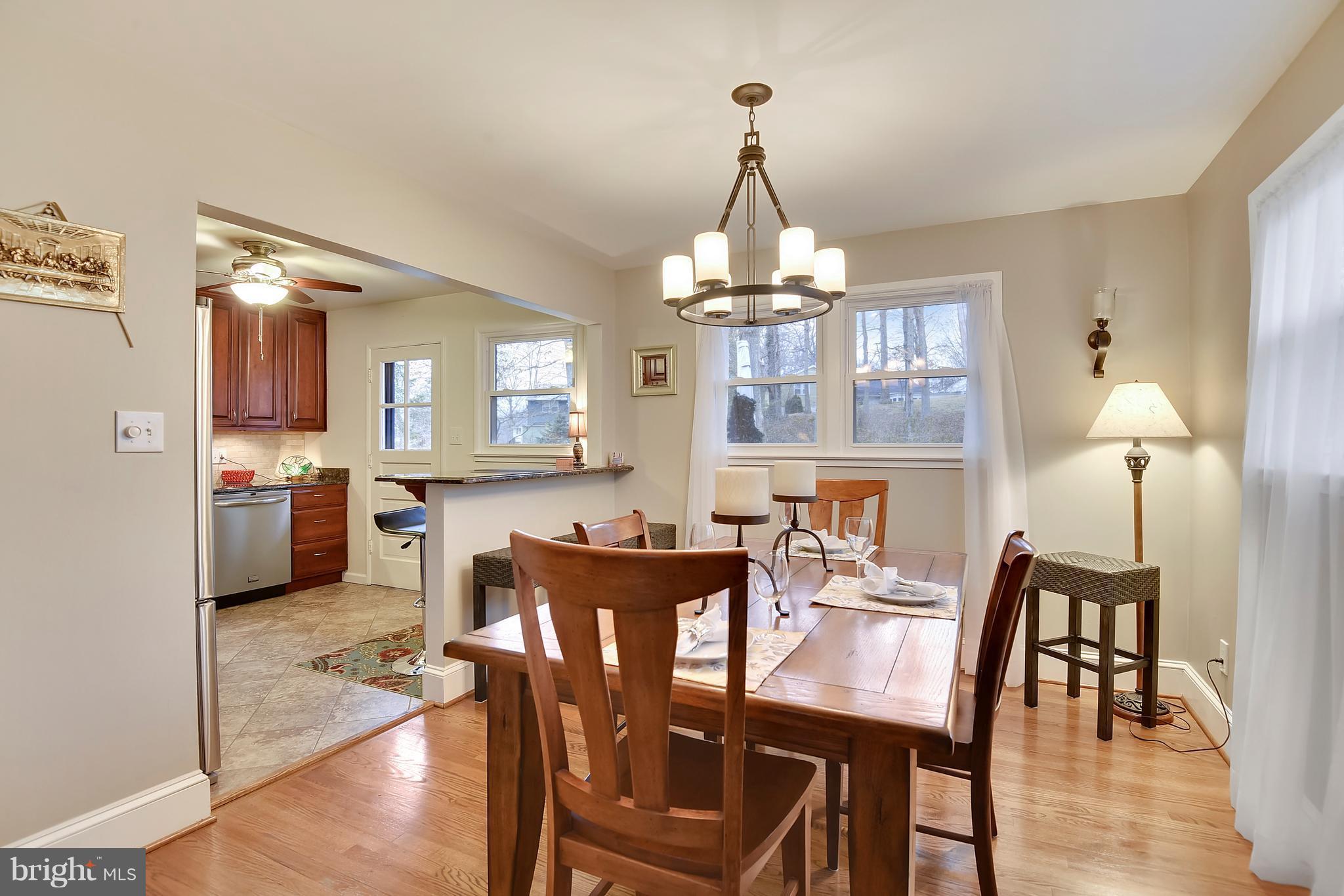 8108 Ellet Road Springfield, VA 22151 - Photo 3 of 21 a view of a dining room and livingroom with furniture wooden floor a chandelier
