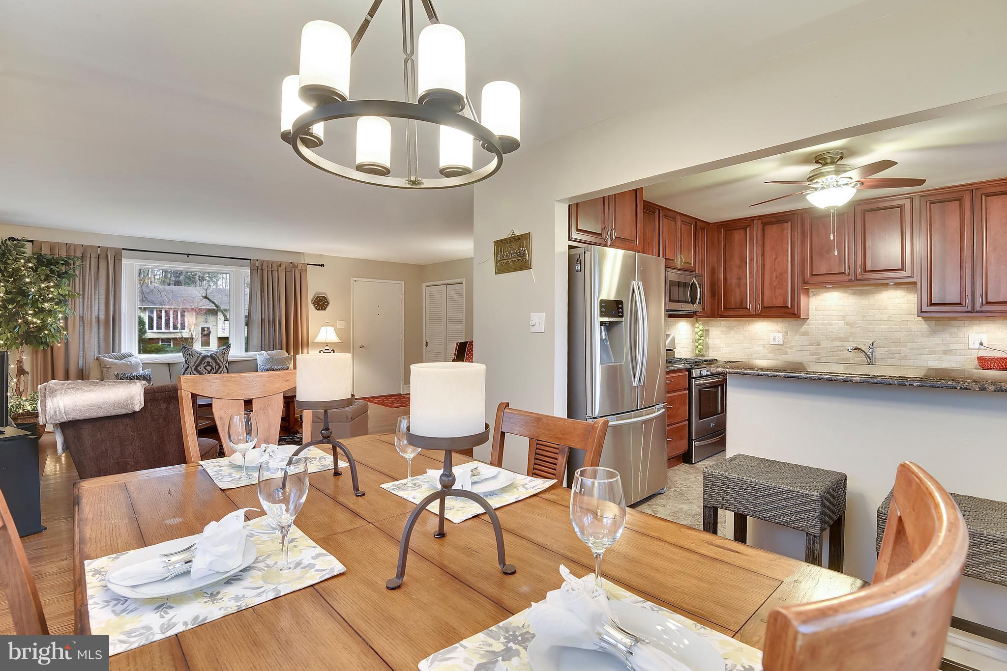 8108 Ellet Road Springfield, VA 22151 - Photo 4 of 21 a kitchen with stainless steel appliances granite countertop a dining table and chairs