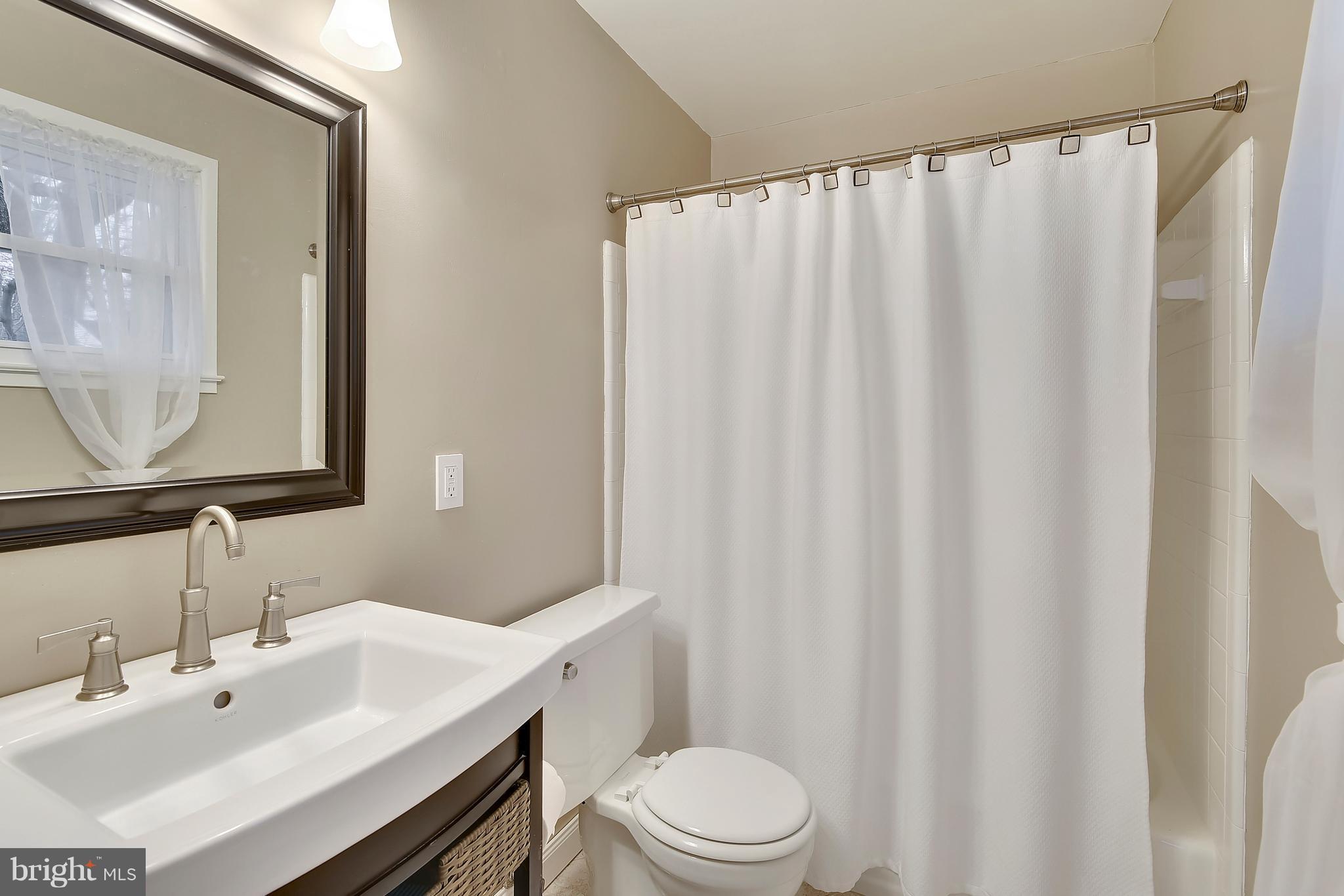 8108 Ellet Road Springfield, VA 22151 - Photo 9 of 21 a bathroom with a sink a toilet and shower curtain