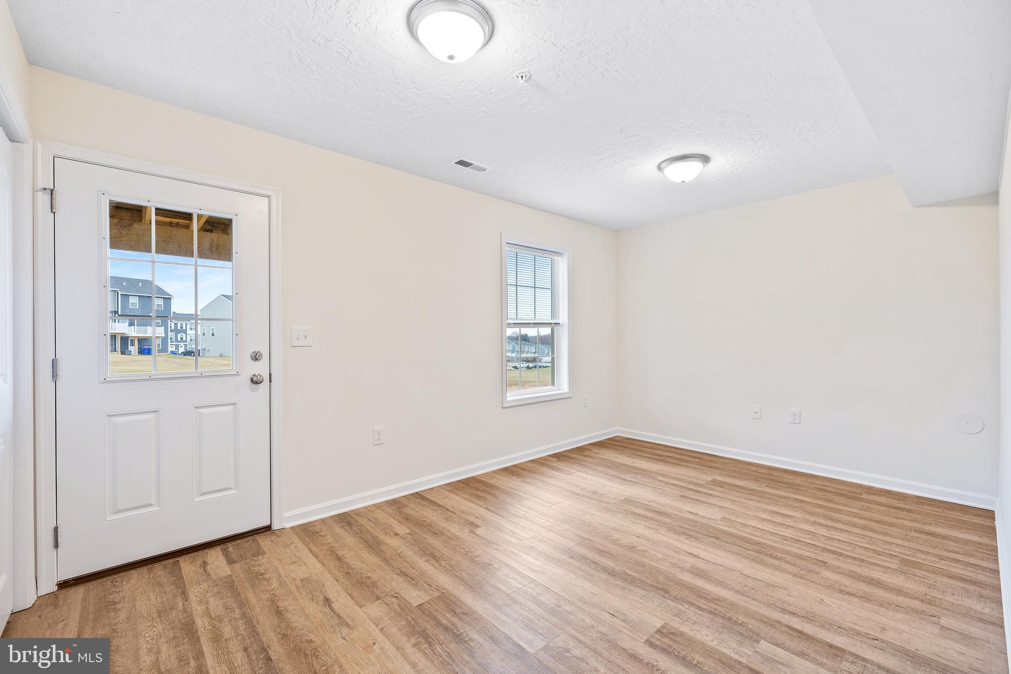 495 South Spring Garden Street, Unit 600 Carlisle, PA 17013 - Photo 23 of 26 an empty room with wooden floor and windows