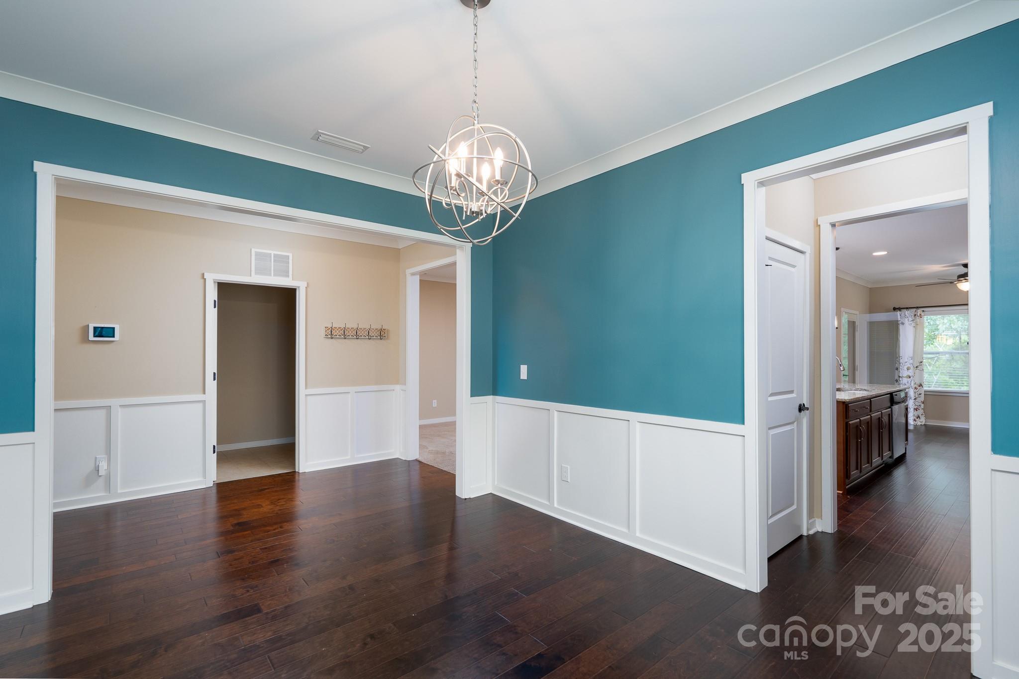 2496 Bergamot Street, Unit 61 Tega Cay, SC 29708 - Photo 15 of 43 a view of a hallway with wooden floor and a kitchen
