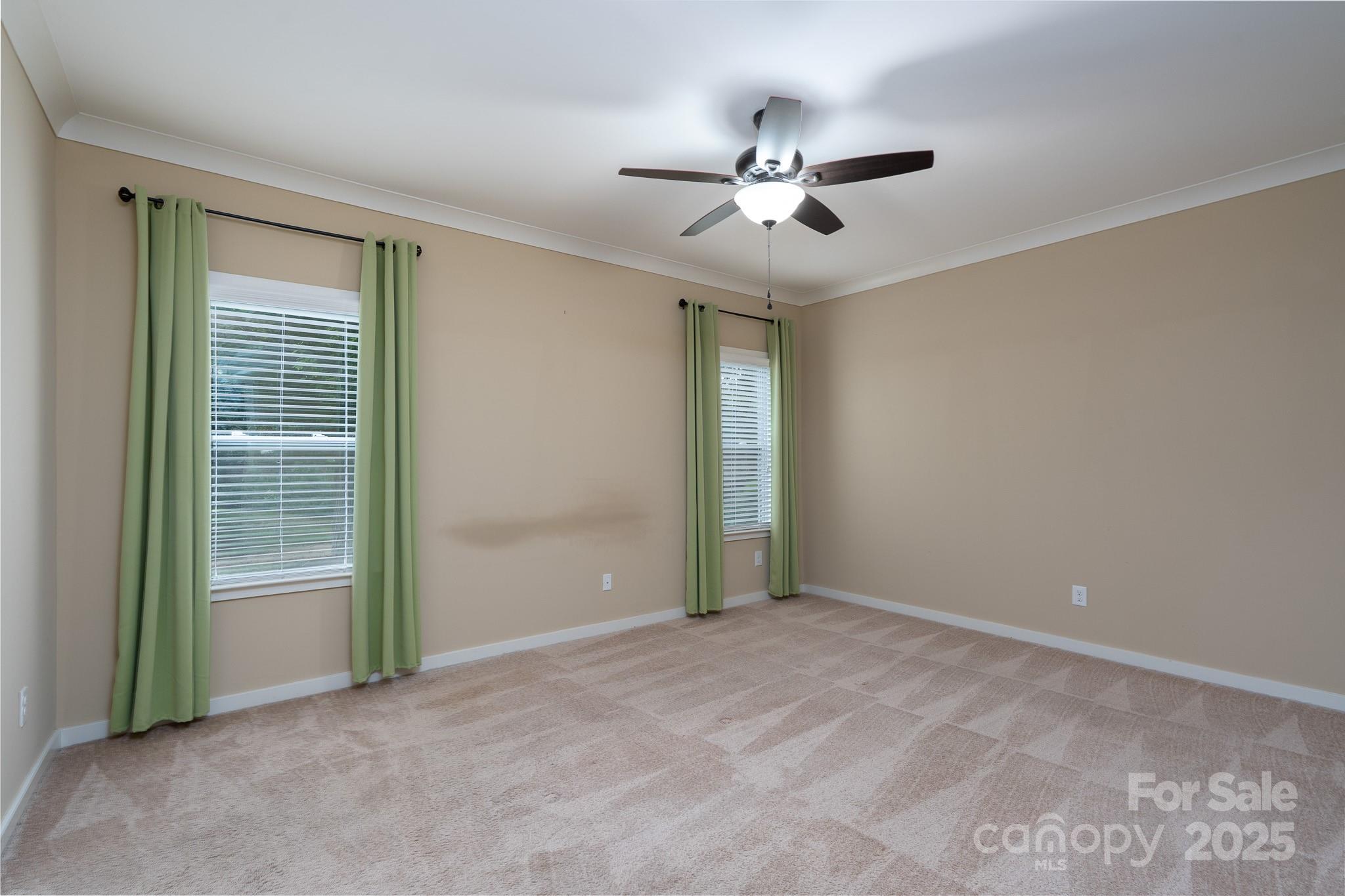 2496 Bergamot Street, Unit 61 Tega Cay, SC 29708 - Photo 18 of 43 a view of an empty room with closet and chandelier fan