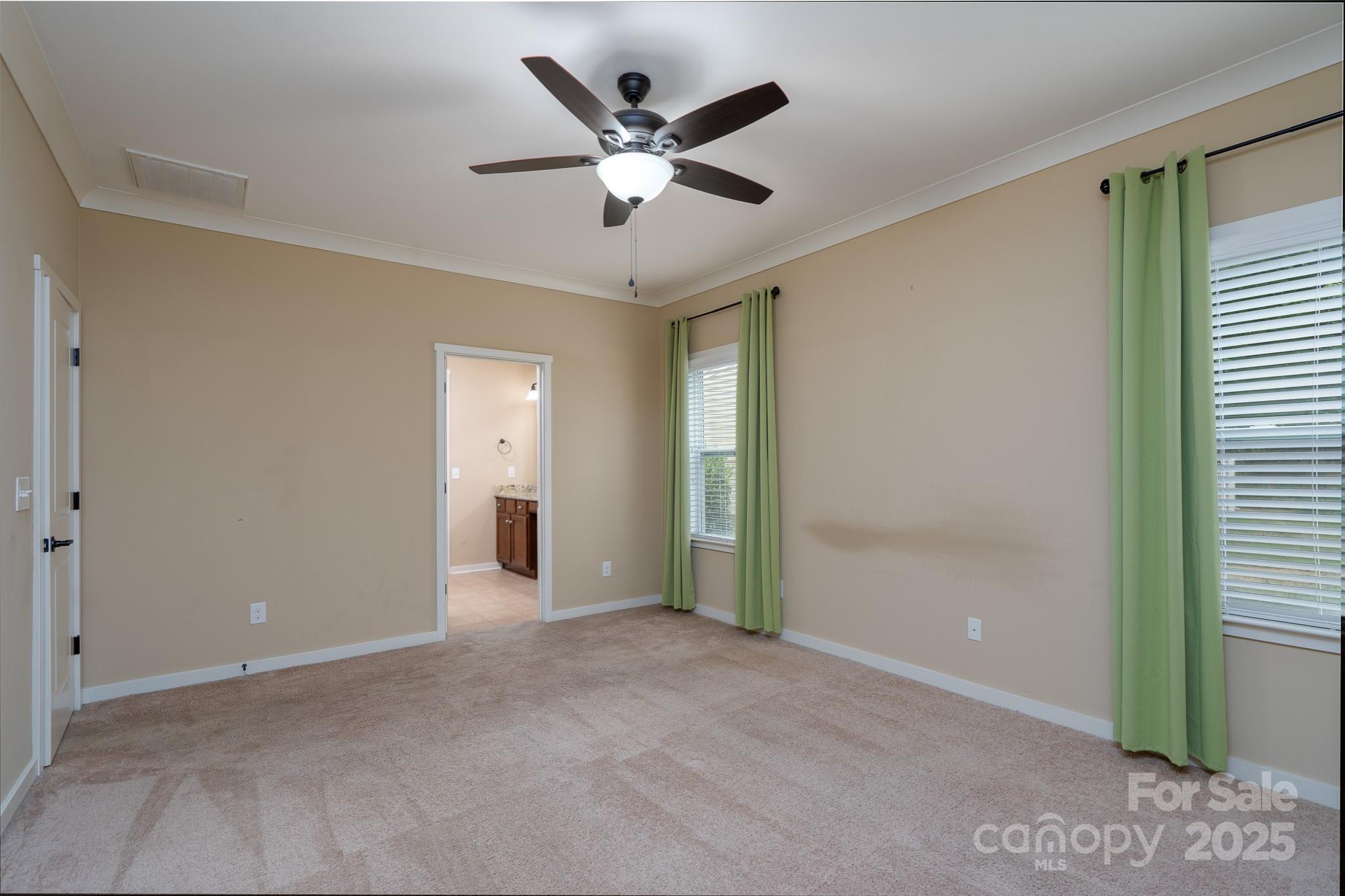 2496 Bergamot Street, Unit 61 Tega Cay, SC 29708 - Photo 19 of 43 a view of an empty room with a ceiling fan and a window