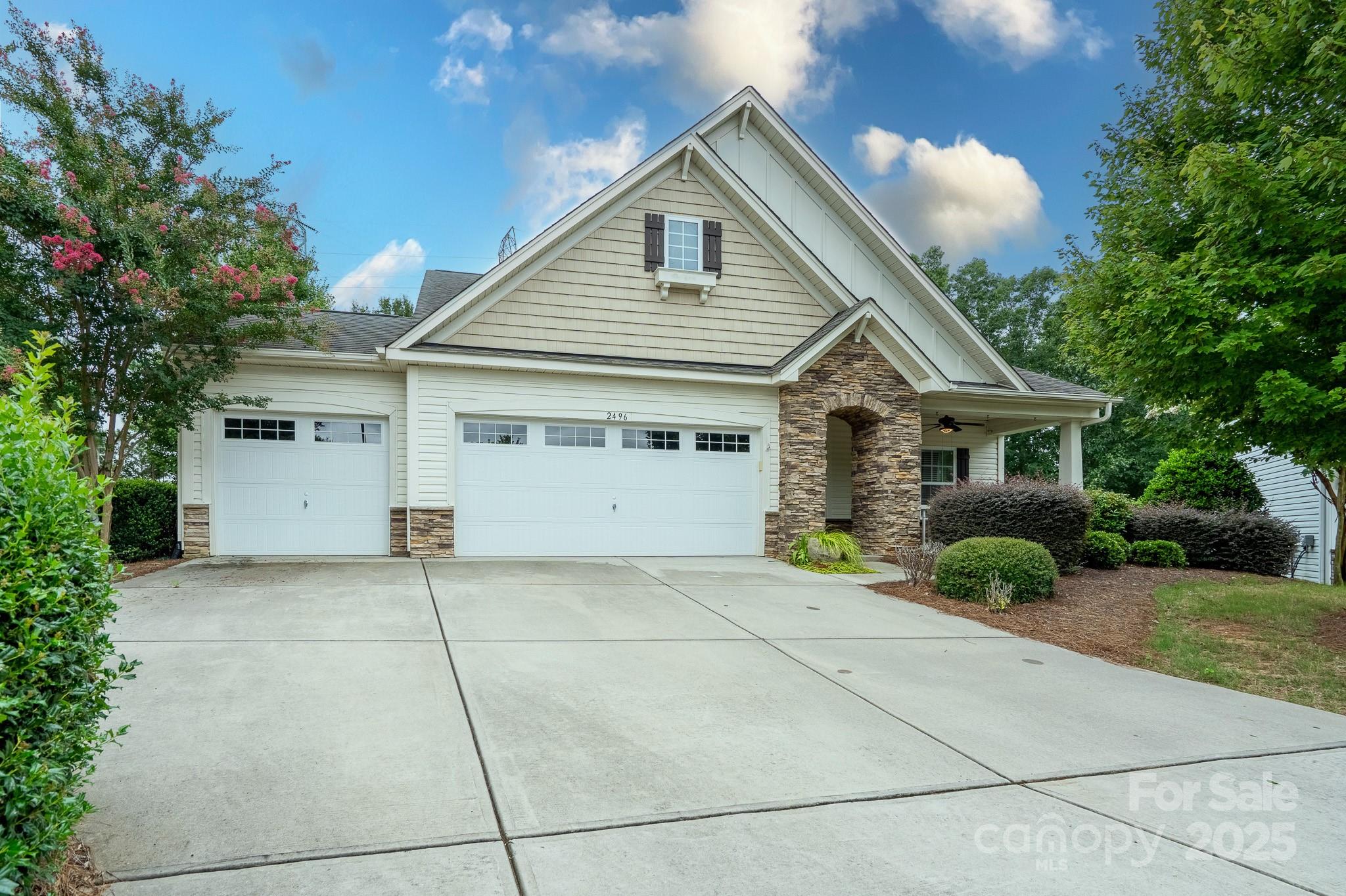 2496 Bergamot Street, Unit 61 Tega Cay, SC 29708 - Photo 2 of 43 a front view of a house with garden