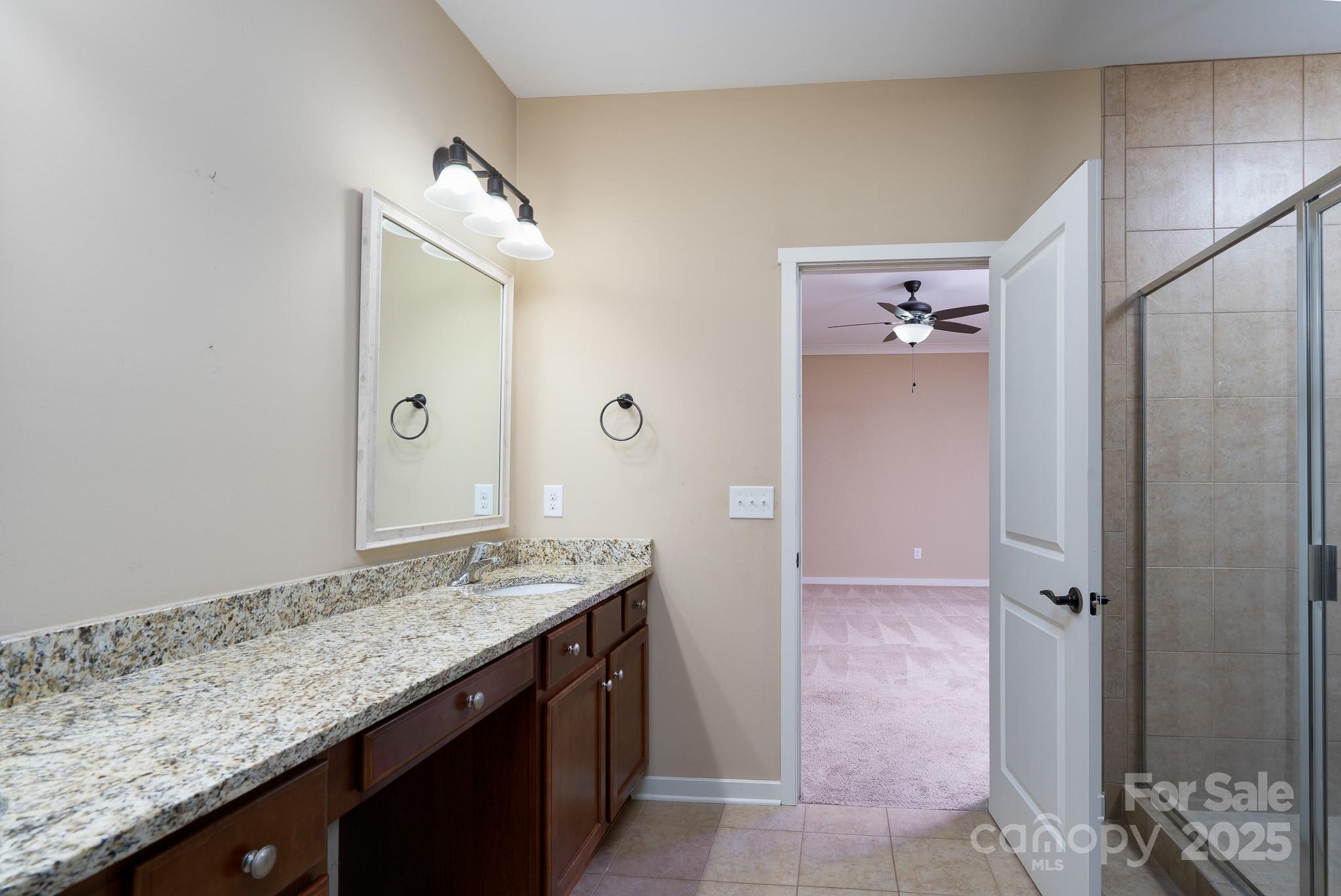 2496 Bergamot Street, Unit 61 Tega Cay, SC 29708 - Photo 21 of 43 a bathroom with a granite countertop sink and a mirror