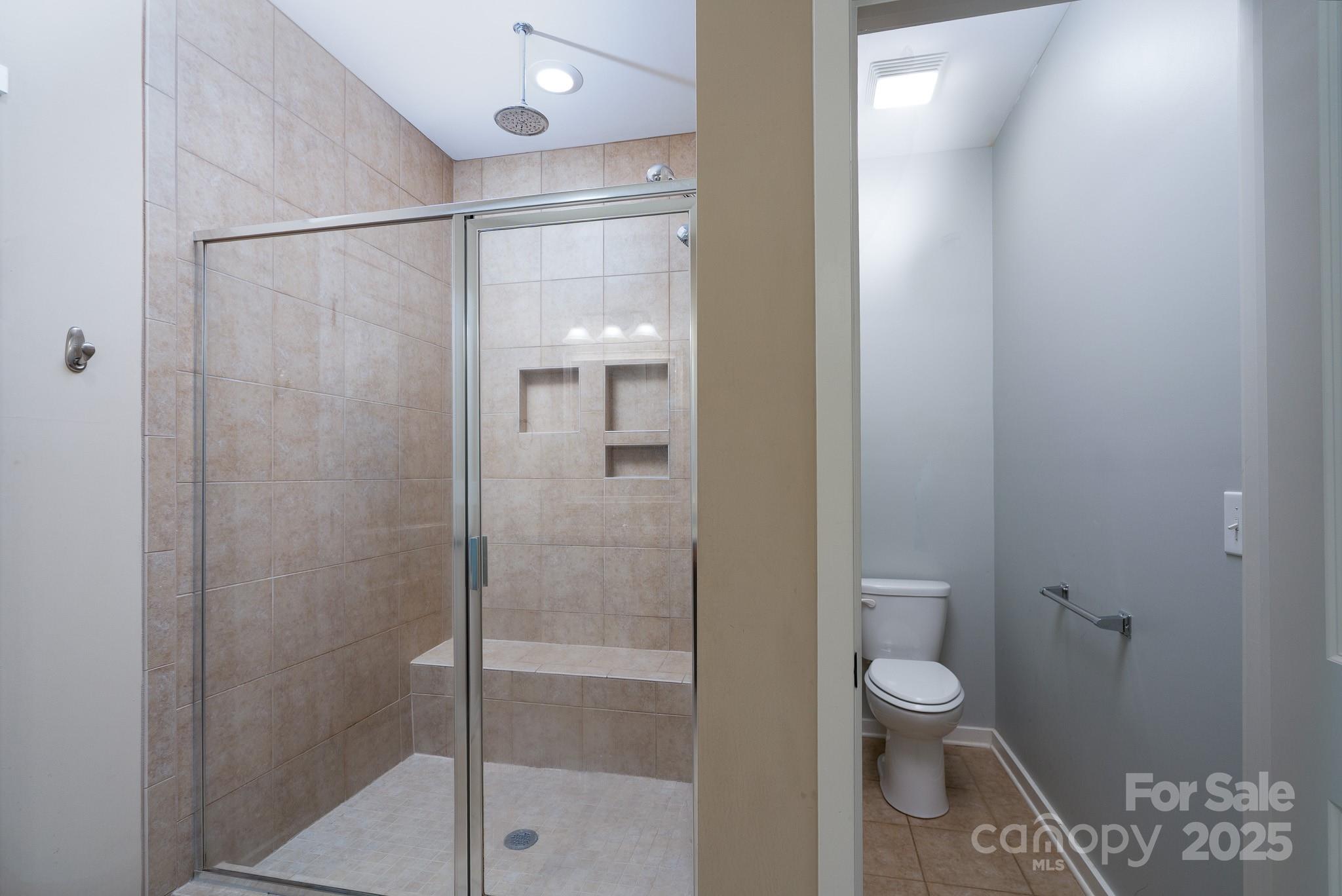 2496 Bergamot Street, Unit 61 Tega Cay, SC 29708 - Photo 23 of 43 a bathroom with a toilet and a shower