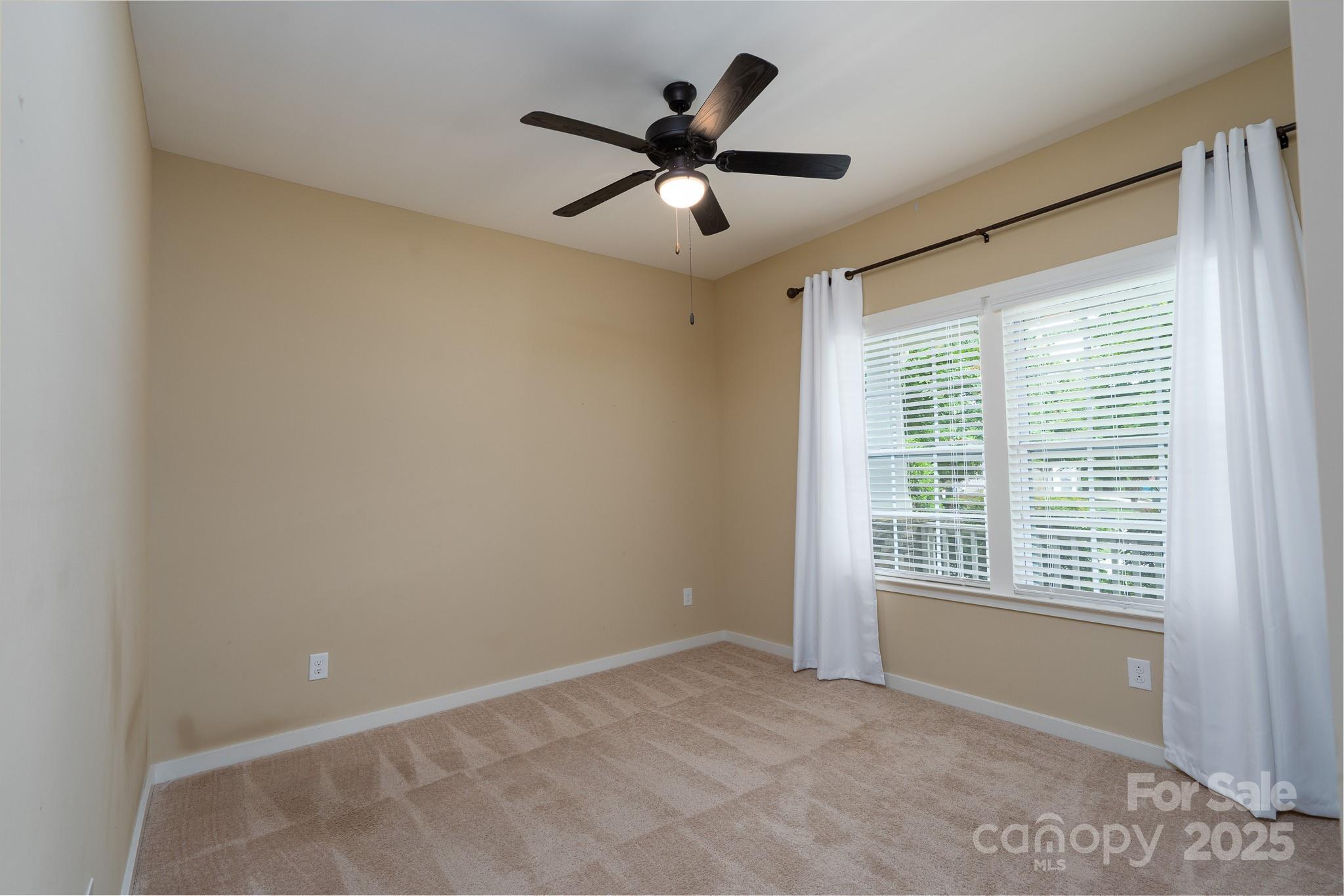 2496 Bergamot Street, Unit 61 Tega Cay, SC 29708 - Photo 26 of 43 a view of an empty room with a window