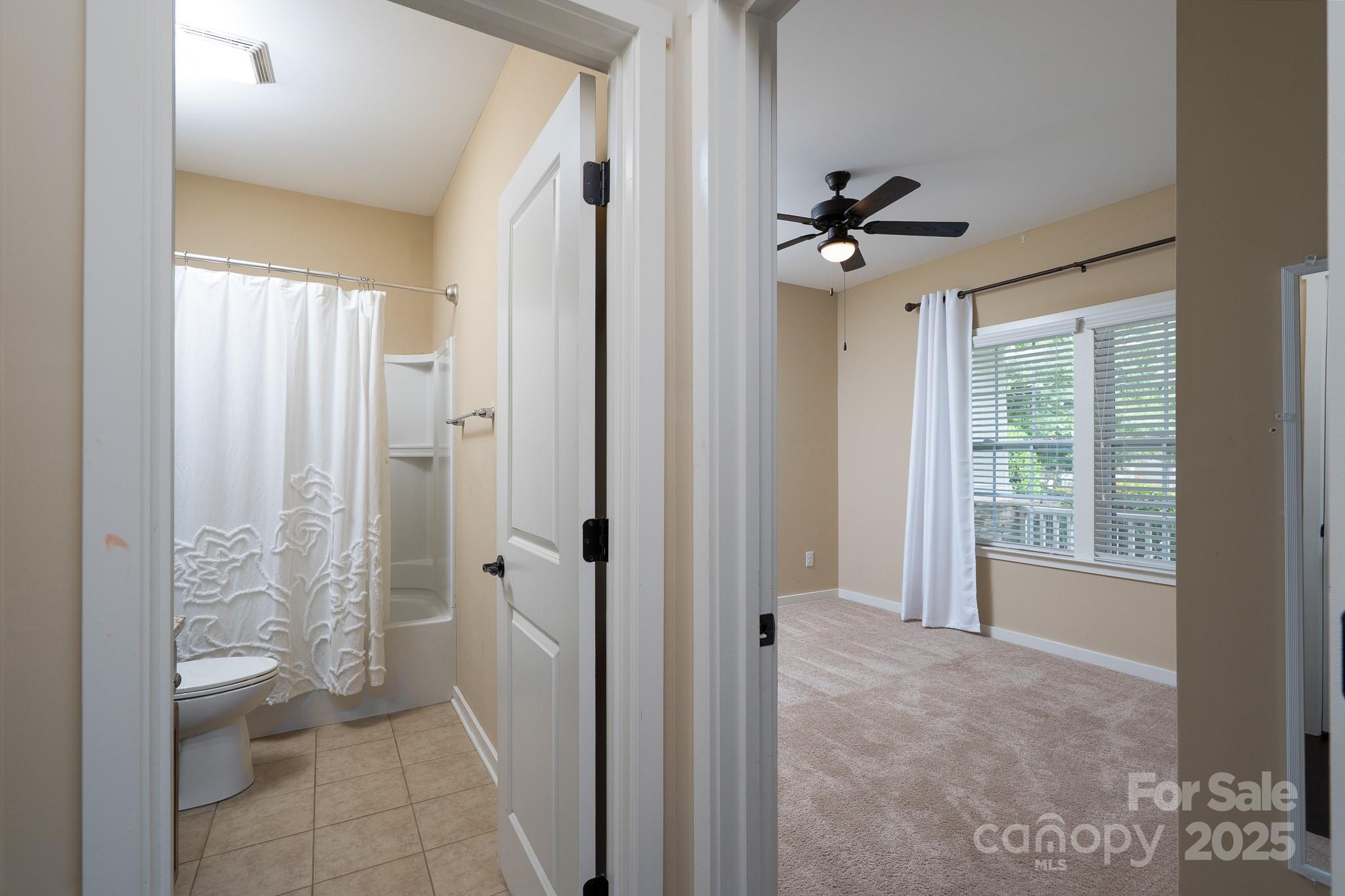 2496 Bergamot Street, Unit 61 Tega Cay, SC 29708 - Photo 27 of 43 a view of a bathroom with a shower and a toilet