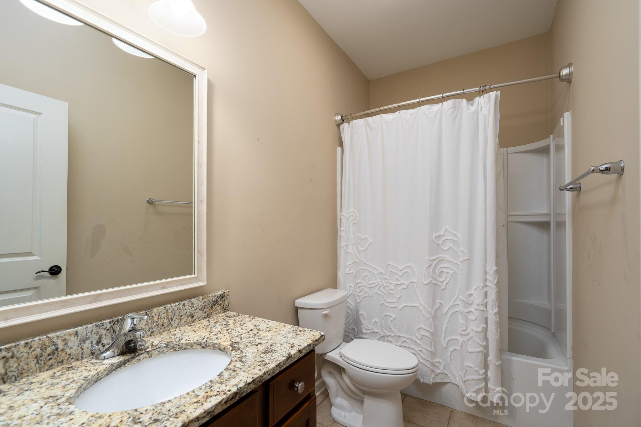 2496 Bergamot Street, Unit 61 Tega Cay, SC 29708 - Photo 28 of 43 a bathroom with a granite countertop sink toilet and shower