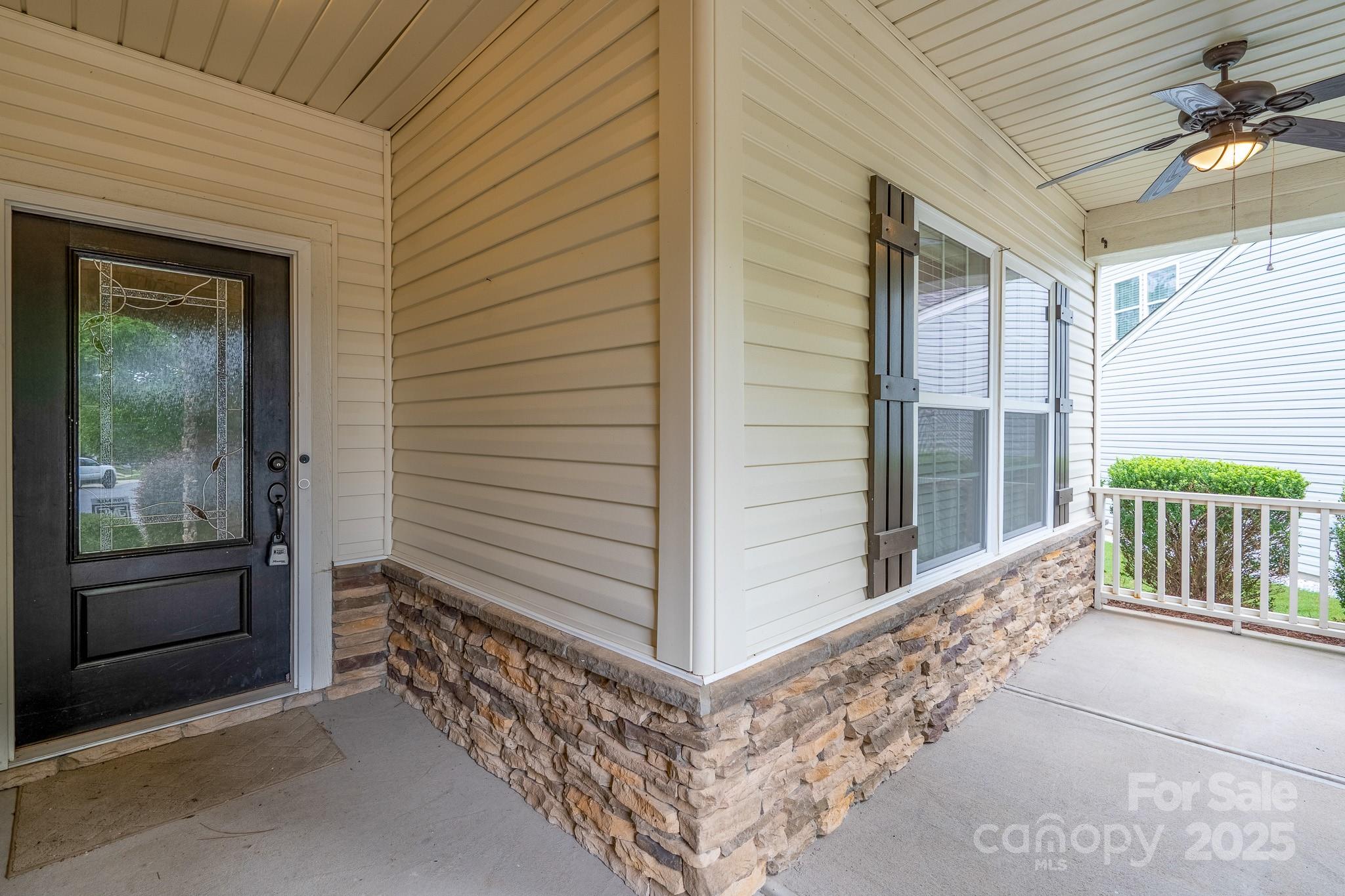 2496 Bergamot Street, Unit 61 Tega Cay, SC 29708 - Photo 3 of 43 a view of a porch with a door and wooden floor