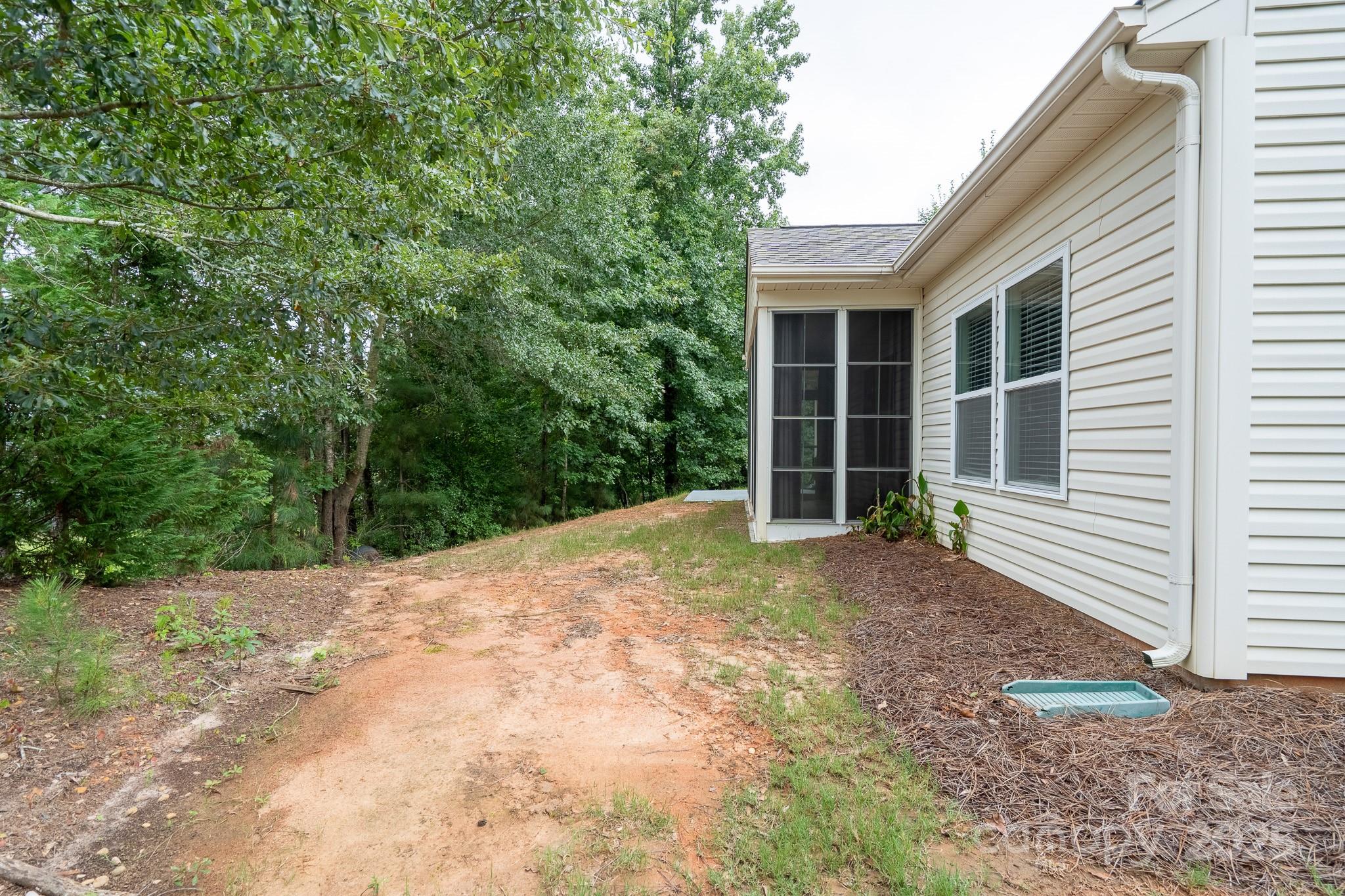 2496 Bergamot Street, Unit 61 Tega Cay, SC 29708 - Photo 38 of 43 a view of a house with a yard and garage