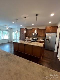 2496 Bergamot Street, Unit 61 Tega Cay, SC 29708 - Photo 41 of 43 a kitchen with kitchen island a stove a sink a refrigerator and a counter top space