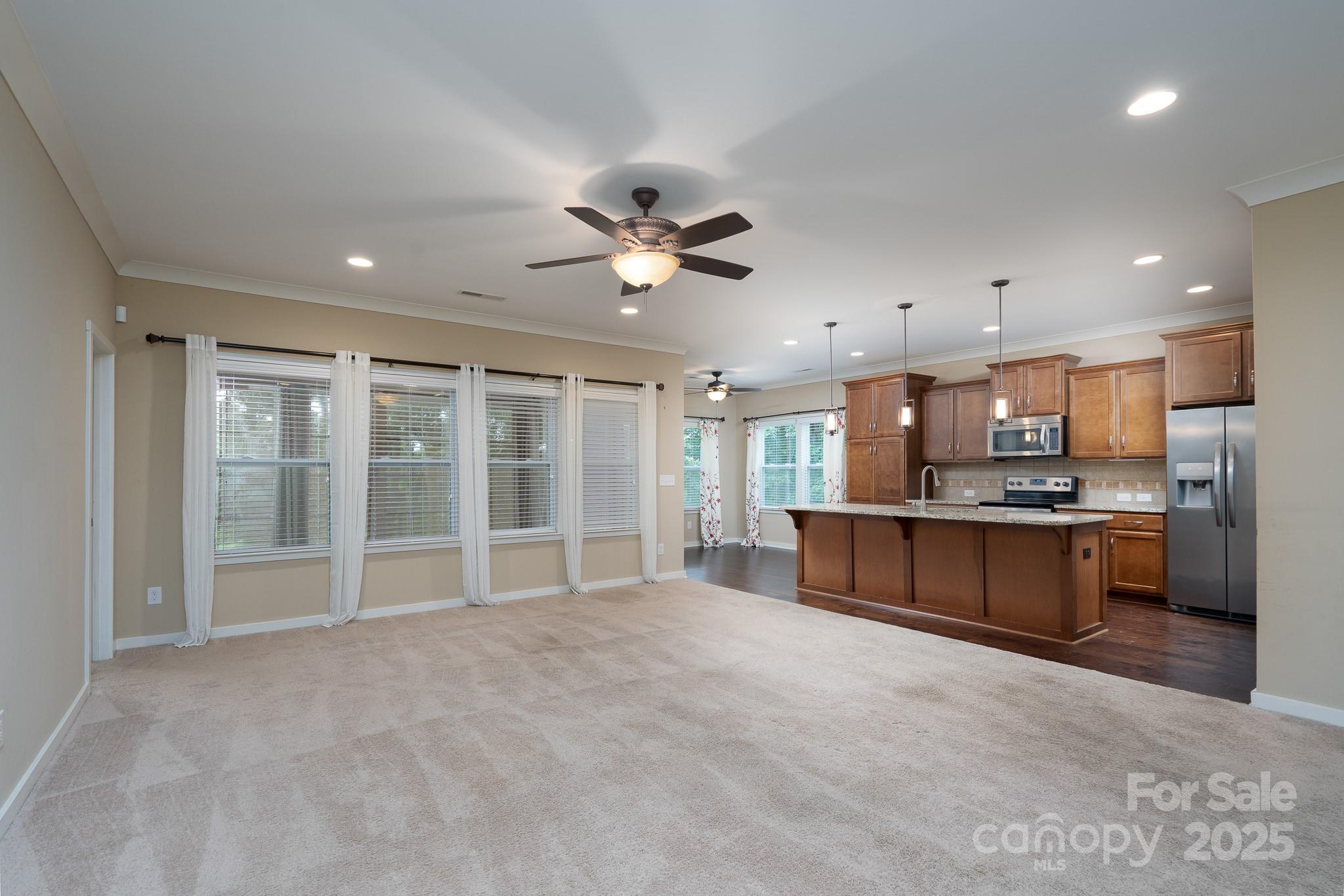 2496 Bergamot Street, Unit 61 Tega Cay, SC 29708 - Photo 6 of 43 a view of an empty room with a kitchen