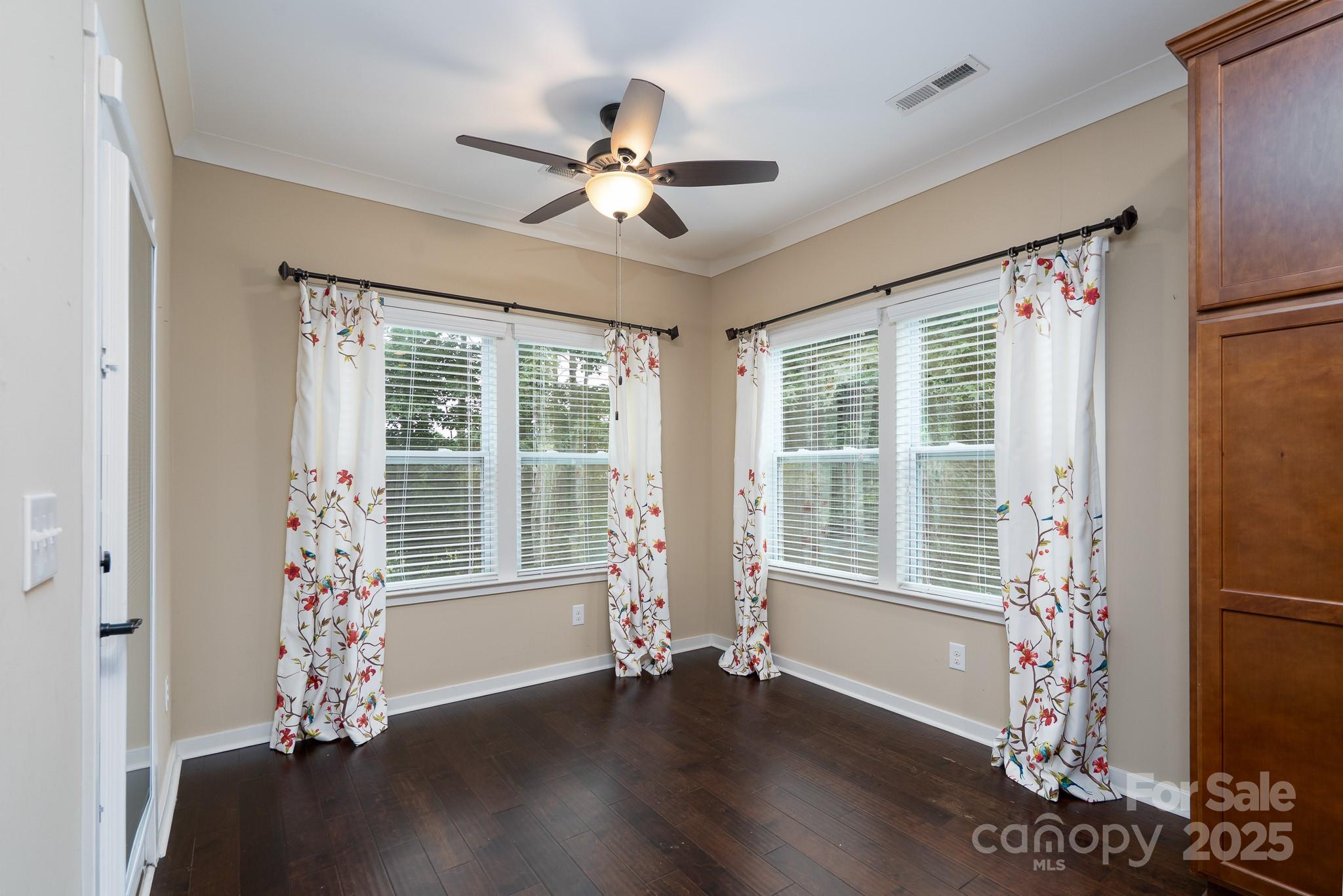 2496 Bergamot Street, Unit 61 Tega Cay, SC 29708 - Photo 9 of 43 a view of an empty room with a window and wooden floor