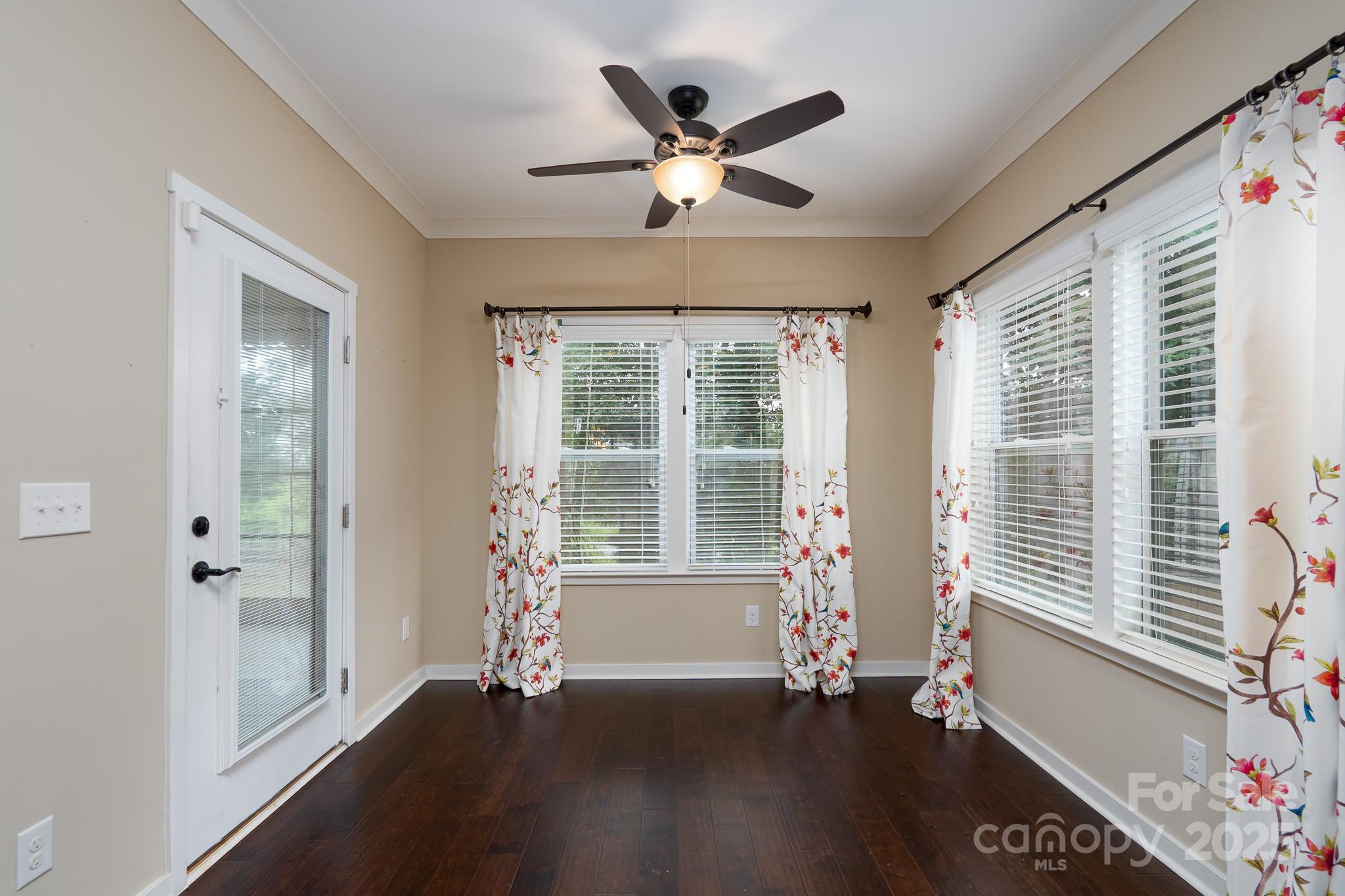 2496 Bergamot Street, Unit 61 Tega Cay, SC 29708 - Photo 10 of 43 a view of an empty room with a window and wooden floor