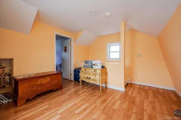 a room with wooden floor and furniture